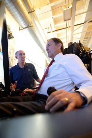 Utah Gov. Gary Herbert lands a simulated F-35 Lightning II aircraft with the assistance of cockpit demonstrator pilot Eric Best at the University of Utah campus, Salt Lake City, Utah, Wednesday, Oct. 7, 2015. The combined efforts of Hill Air Force Base and Lockheed Martin brought the interactive cockpit demonstrator to the university. While there, civic leaders and the public had a unique opportunity to experience and learn about the Air Force's newest and most advanced fighter. Hill Air Force Base's 388th and 419th Fighter Wings are the first in the Air Force to fly combat-coded F-35s. (U.S. Air Force photo by R. Nial Bradshaw)