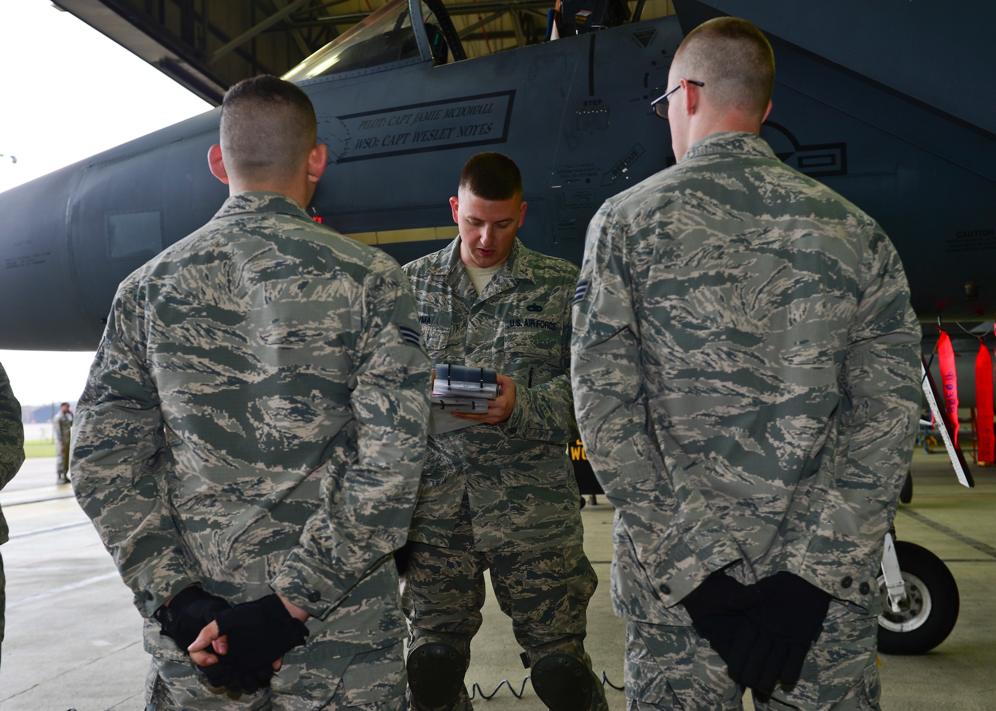 Weapons load crew members of the 48th Aircraft Maintenance Squadron are issued their positions during a load crew competition on Royal Air Force Lakenheath, England, Oct. 6, 2015. The load crew competition pits Airmen from the 492nd, 493rd and 494th Aircraft Maintenance Units against each other to see who will hold the reigning title of best load crew of the quarter. (U.S. Air Force photo by Senior Airman Nigel Sandridge/Released)