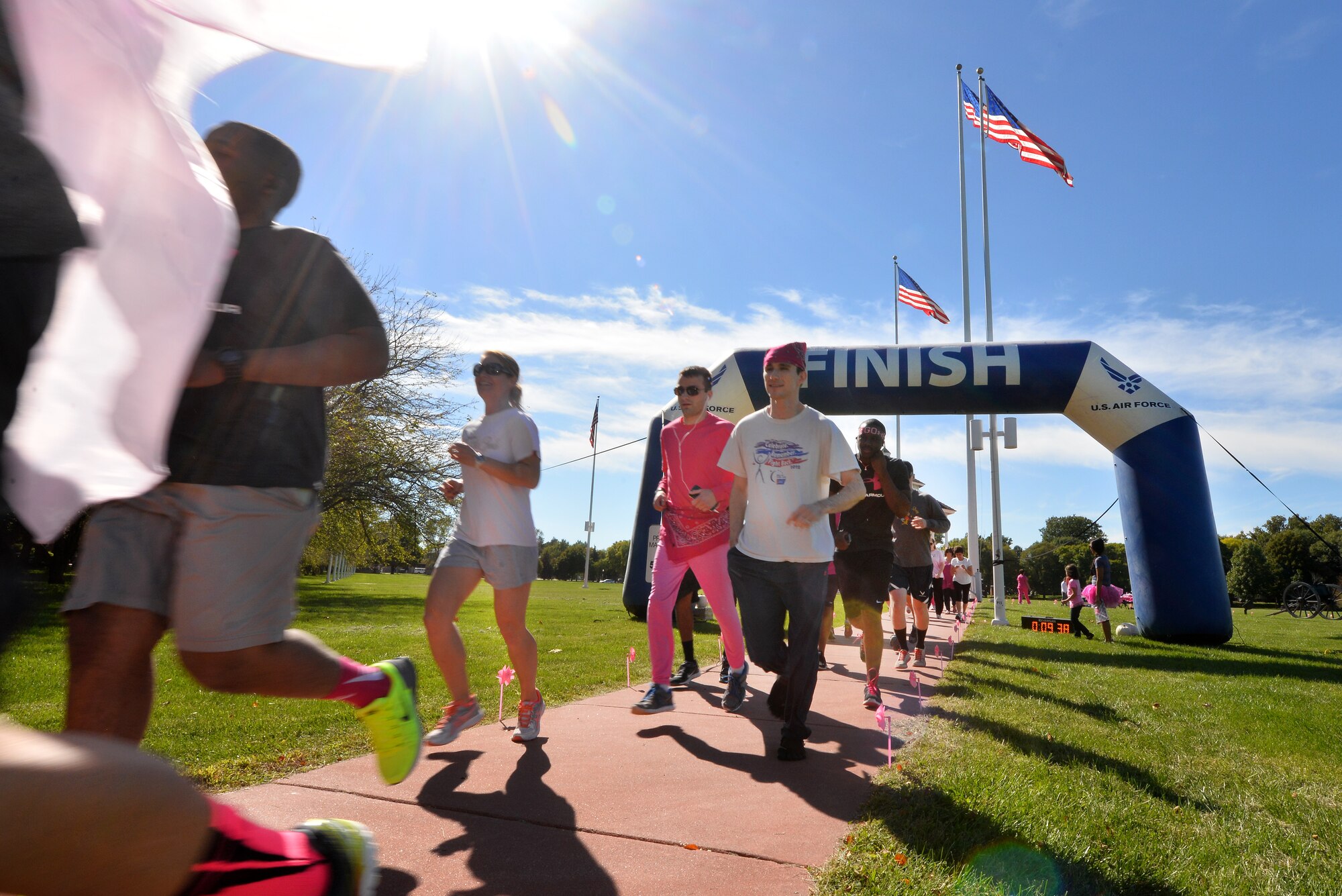 Festive runners, dressed in pink, begin the first Breast Cancer Awareness 5K Oct 2. on the Offutt Air Force Base, Neb., parade grounds.  Following the run, participants were greeted with a fruit buffet, breast cancer awareness merchandise and a raffle for prize packages.  (U.S. Air Force photo by Josh Plueger/Released))