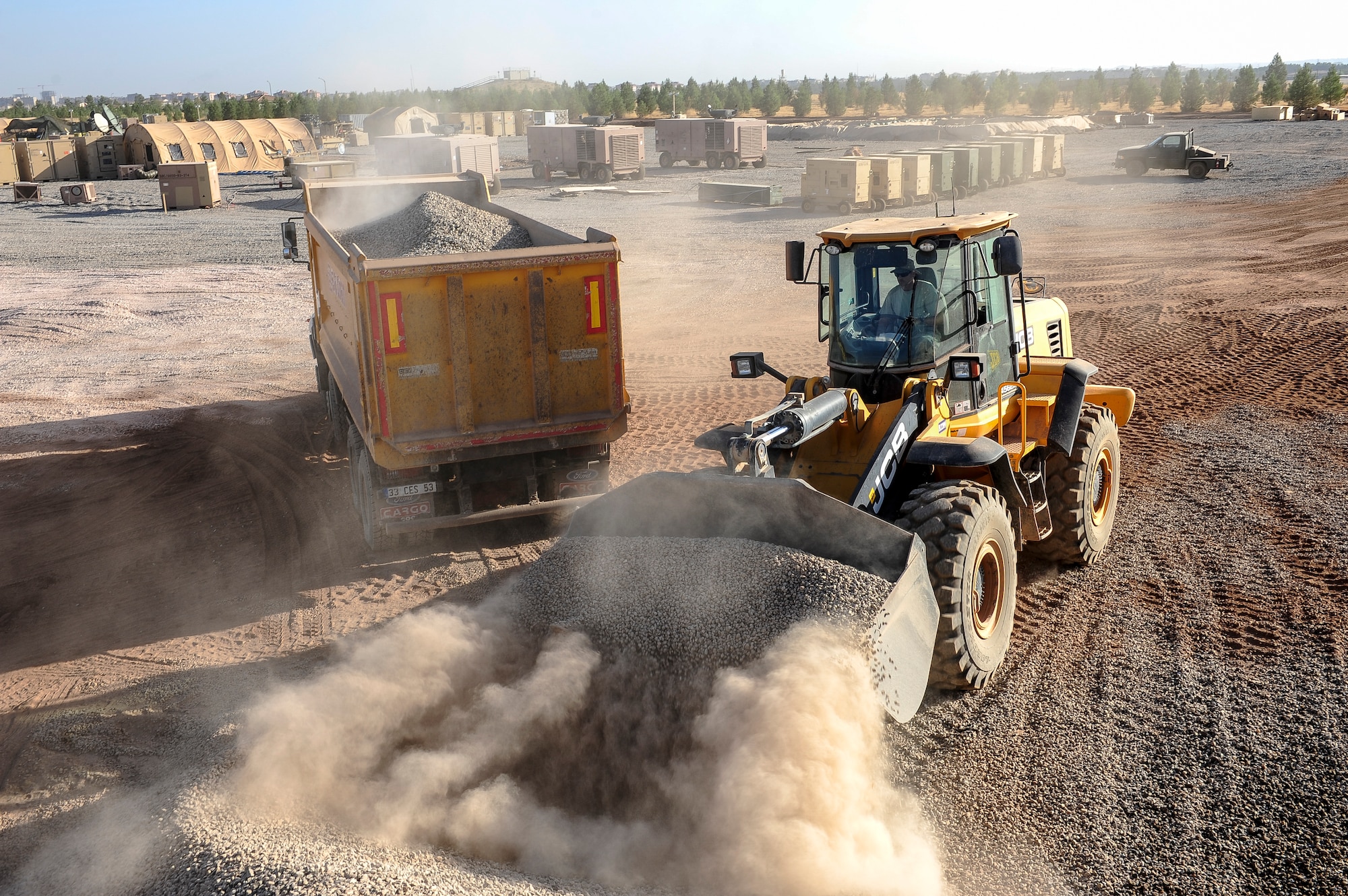 Staff Sgt. Joseph Roach, 786th Civil Engineer Squadron pavements and construction equipment operator, loads the back of a dump truck with gravel Sept. 24, 2015, at Diyarbakir Air Base, Turkey. Airmen from the 435th Construction Training Squadron and 786th CES deployed to Diyarbakir in early August 2015 to lay the foundation for personnel recovery forces deploying to the south east Turkish base. (U.S. Air Force photo by Airman 1st Class Cory W. Bush/Released)