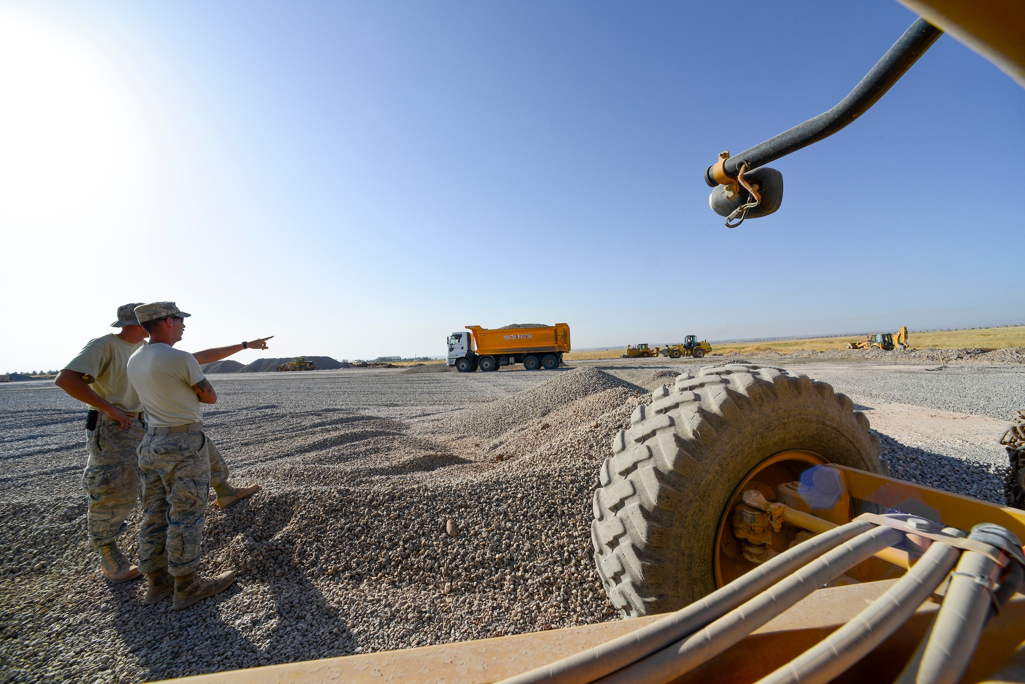Staff Sgt. Joseph Roach, 786th Civil Engineer Squadron pavements and construction equipment operator, and Staff Sgt. Jack DeMato, 435th Construction Training Squadron pavements and construction equipment operator, scope out the current area of operations Sept. 24, 2015, at Diyarbakir Air Base, Turkey. Over the past 36 days the team of Airmen have dumped, graded, leveled and rolled more than 78,000 tons of rocks and gravel. (U.S. Air Force photo by Airman 1st Class Cory W. Bush/Released)