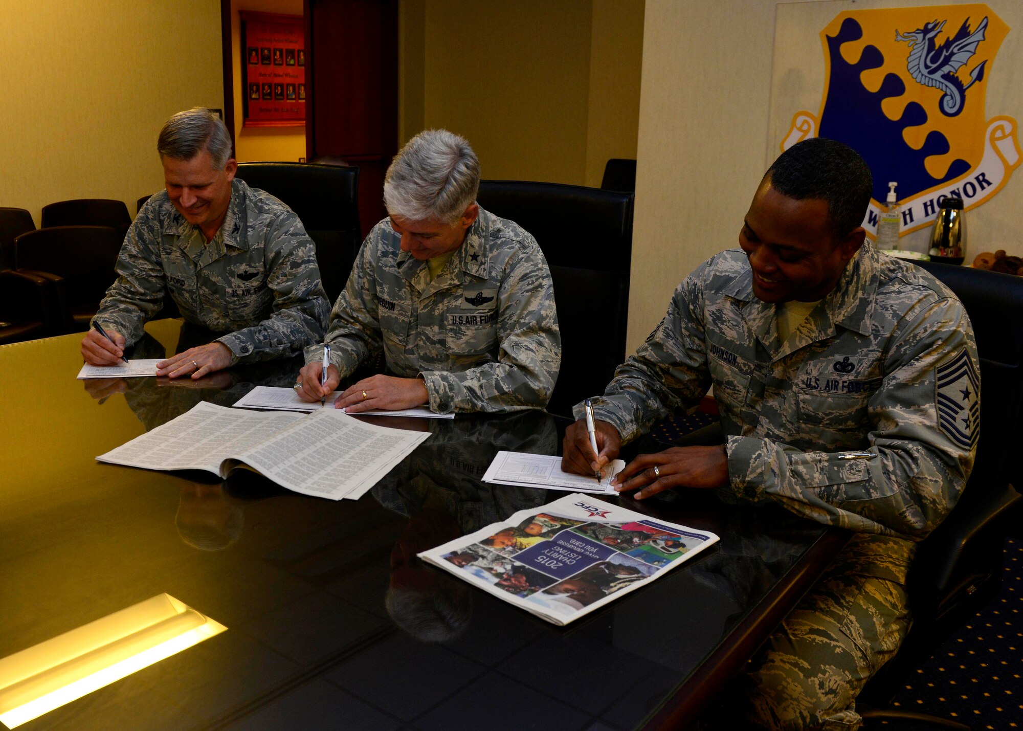 Team Aviano leadership sign their Combined Federal Campaign contribution Oct. 7, 2015, at Aviano Air, Base, Italy.  The CFC makes it easy for, members to contribute by providing three simple ways to donate. Donors have the option to use a pledge card, set up a recurring allotment through MyPay or donate through the CFC-O eGiving website. (U.S. Air Force phot By Airman 1st Class Cary Smith/Released)