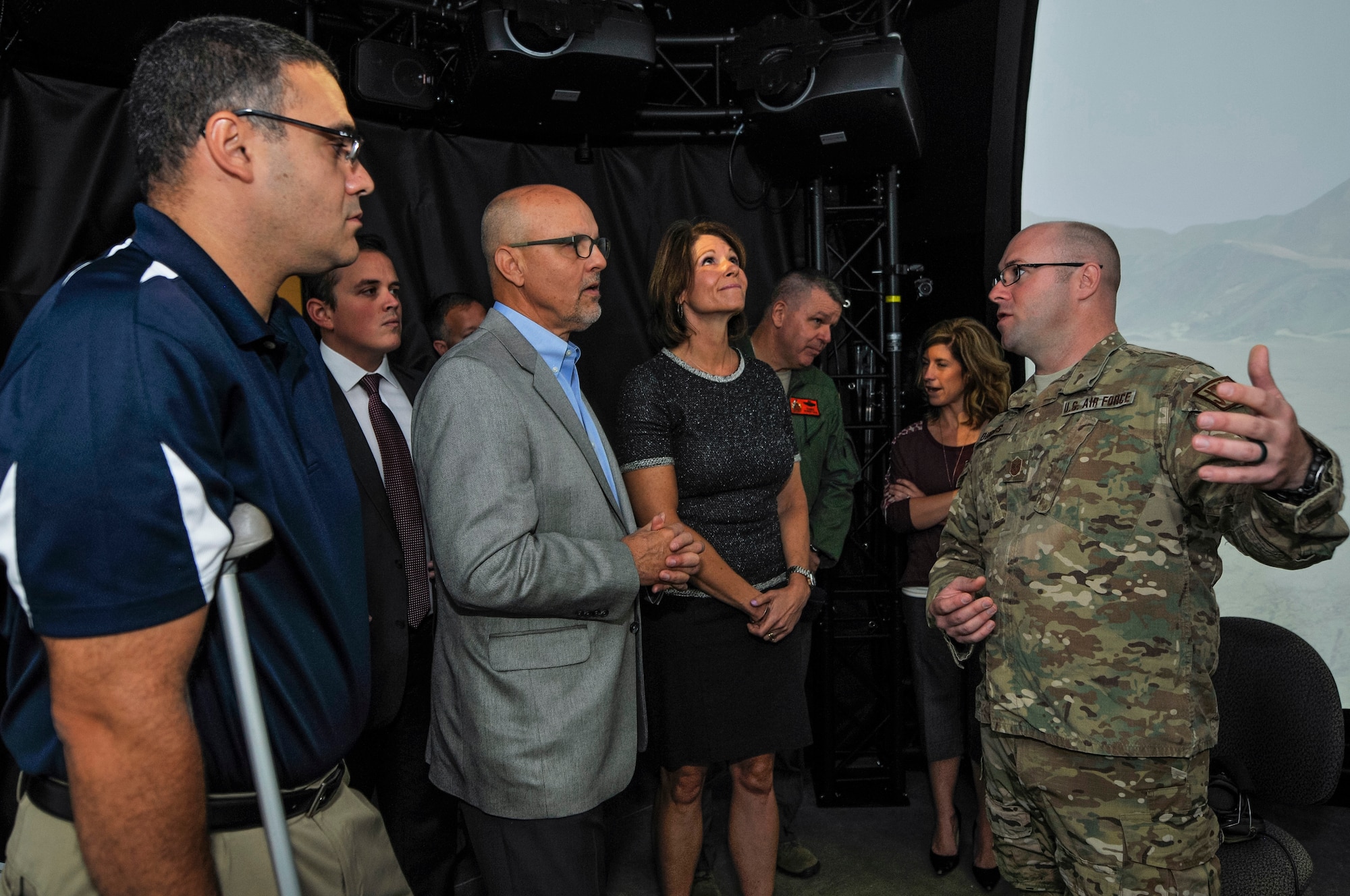 U.S. Air Force Master Sgt. Eric M. Dubois, operations superintendent at the 169th Air Support Operations Squadron, Illinois Air National Guard, explains to, from left, state Rep. Michael Unes, R-East Peoria., state Sen. David Koehler, D-Peoria., and U.S. Rep. Cheri Bustos, D-Ill., how the Air National Guard Advanced Joint Terminal Attack Controller Training System works after a ribbon cutting ceremony at the 182nd Airlift Wing in Peoria, Ill., Oct. 5, 2015. Peoria’s 169th Air Support Operations Squadron TACPs teamed up with the QuantaDyn Corporation to help create the AAJTS, which is expected to potentially save the government $95 million through fiscal year 2018 by reducing the cost of qualification and continuation training by 48 percent. (U.S. Air National Guard photo by Staff Sgt. Lealan Buehrer/Released)
