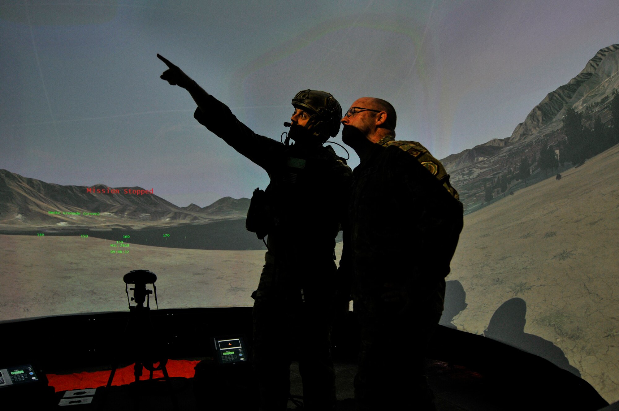 U.S. Air Force Tech. Sgt. Cody L. Canfield, tactical air control party specialist with the 169th Air Support Operations Squadron, Illinois Air National Guard, points out a close air support aircraft to Master Sgt. Eric M. Dubois while training in the Air National Guard Advanced Joint Terminal Attack Controller Training System at the 182nd Airlift Wing in Peoria, Ill., Oct. 5, 2015. Peoria’s TACPs teamed up with the QuantaDyn Corporation to help create the AAJTS, which is expected to potentially save the government $95 million through fiscal year 2018 by reducing the cost of qualification and continuation training by 48 percent. (U.S. Air National Guard photo by Staff Sgt. Lealan Buehrer/Released)