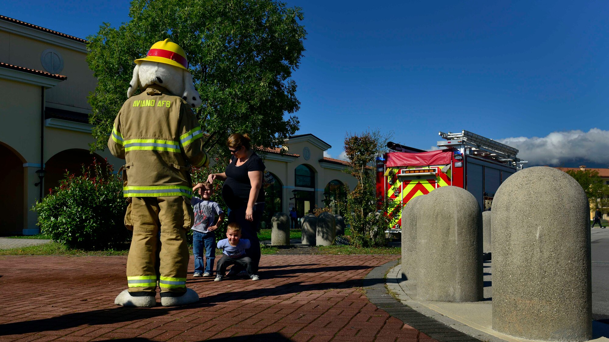 Sparky the fire dog greets attendees during Fire Prevention Week, Oct. 5, 2015, at Aviano Air Base, Italy. The weeklong events promoted safety precautions to help prevent fires. (U.S. Air Force photo by Airman 1st Class Cary Smith/Released)