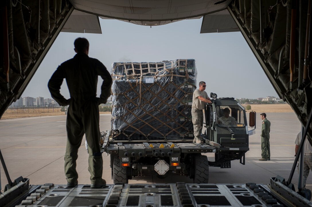 Senior Airman Dustin Dixon, 435th Contingency Response Squadron loadmaster, oversees the off-loaded of from a C-130J Super Hercules Sept. 15, 2015, at Diyarbakir Air Base, Turkey. The equipment delivery is in support of the 435th CRG’s build up of U.S. Air Forces Central Command’s personnel recovery deployment site and facilities at DAB. The CRG serves as U.S. Air Forces Europe and Air Forces in Africa's only expeditionary open-the-base force. (U.S. Air Force photo by Airman Cory W. Bush/Released)