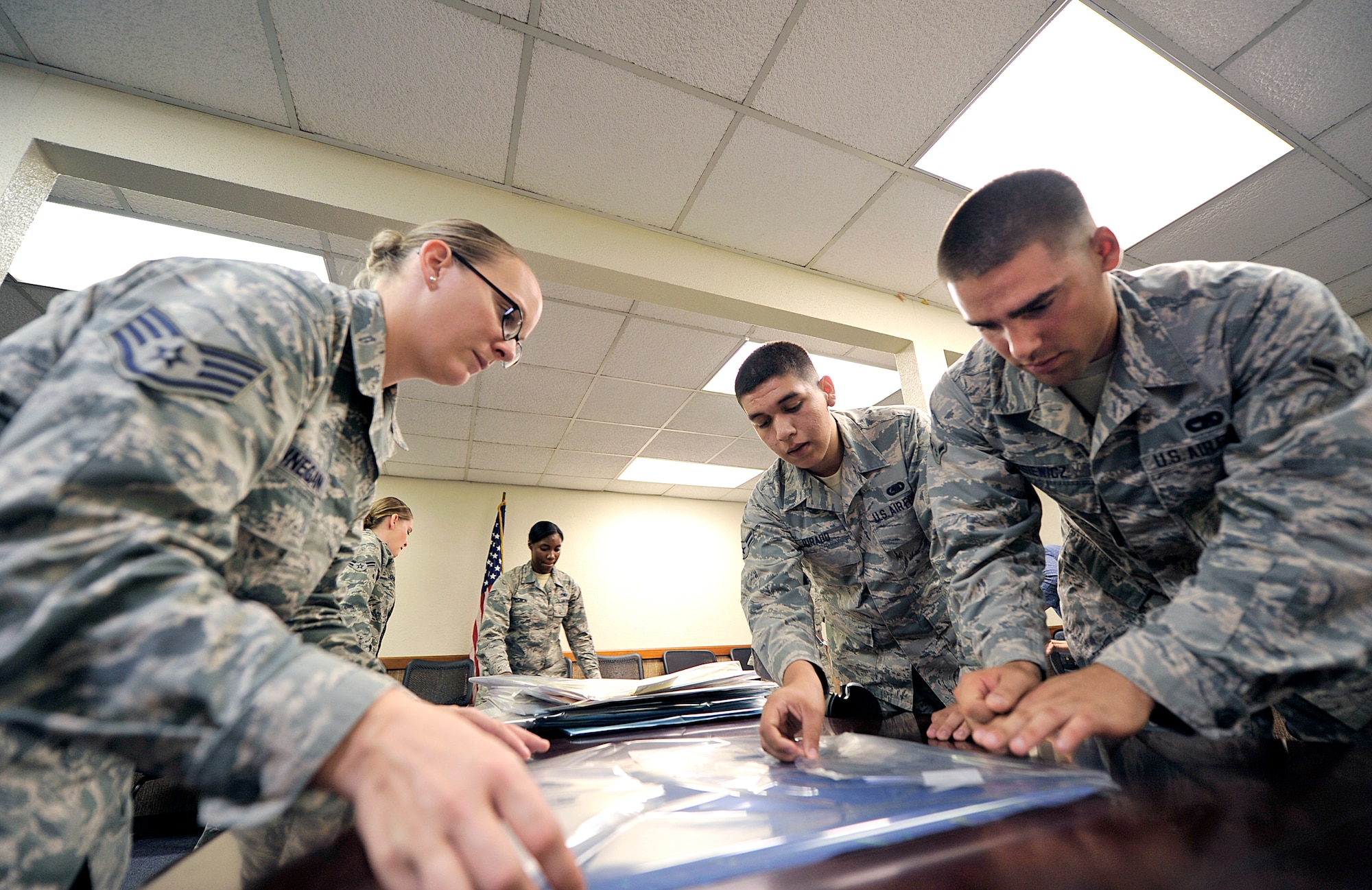 Volunteers wrap artwork drawn by special needs children Oct. 7, 2015, on Kadena Air Base, Japan. The Kadena Special Olympics Art Exhibit has been held at Main City Shopping Mall San-A in Uruma City since 2006. The event was hosted by the Kadena Special Olympics committee to raise awareness and showcase the talents of athletes preparing for the upcoming 16th Annual KSO scheduled for Nov. 7. (U.S. Air Force photo by Naoto Anazawa)