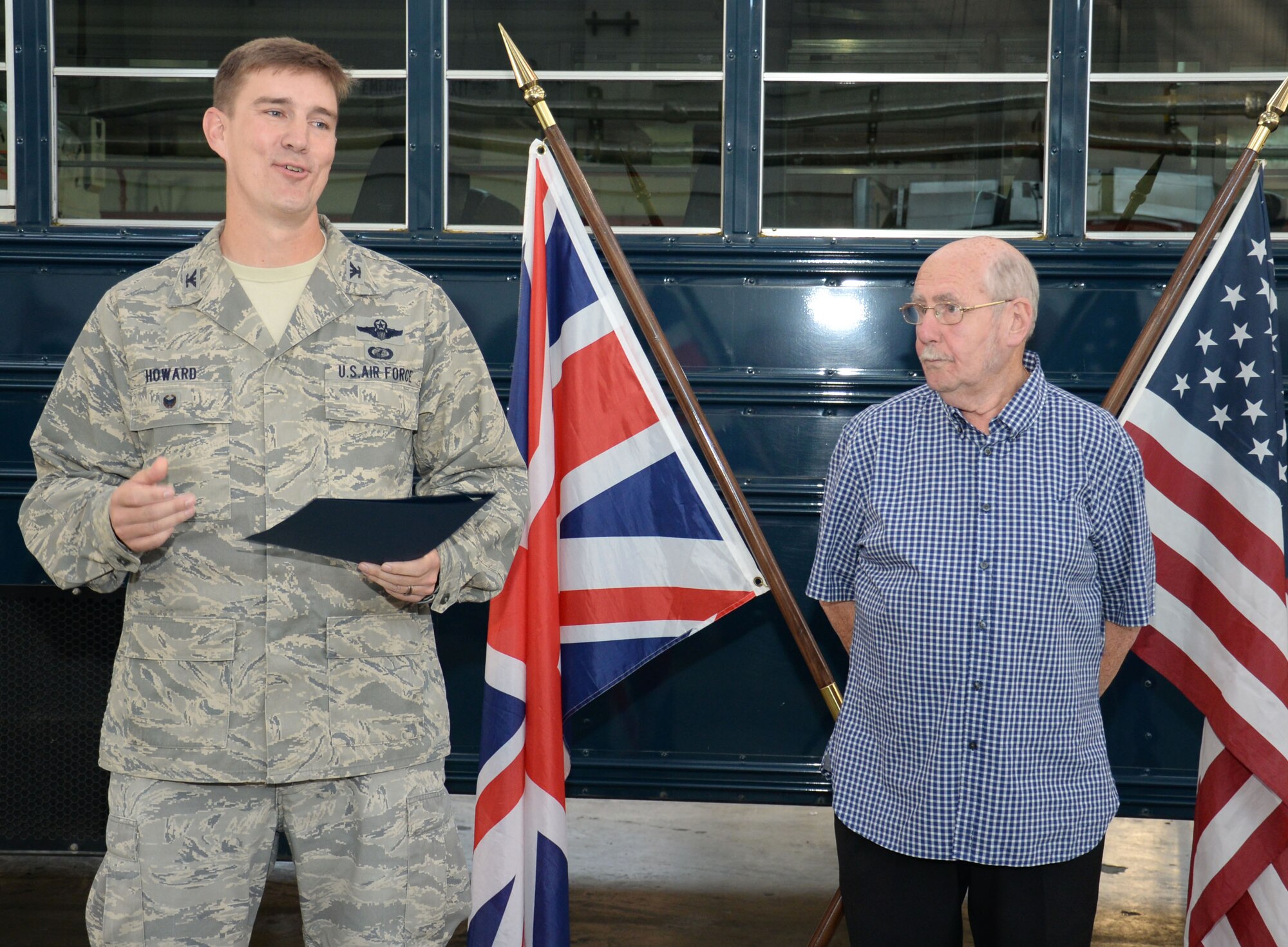 U.S. Air Force Col. John Howard, left, 100th Air Refueling Wing vice commander, presents John Lake, retired Ministry of Defence vehicle operator, with a certificate of service to the United States of America following more than 30 years of service Oct. 1, 2015, at RAF Mildenhall, England. During his career, Lake provided transportation support for five U.S. presidents, including Presidents Ronald Reagan and Barack Obama. (U.S. Air Force photo by Gina Randall/Released)