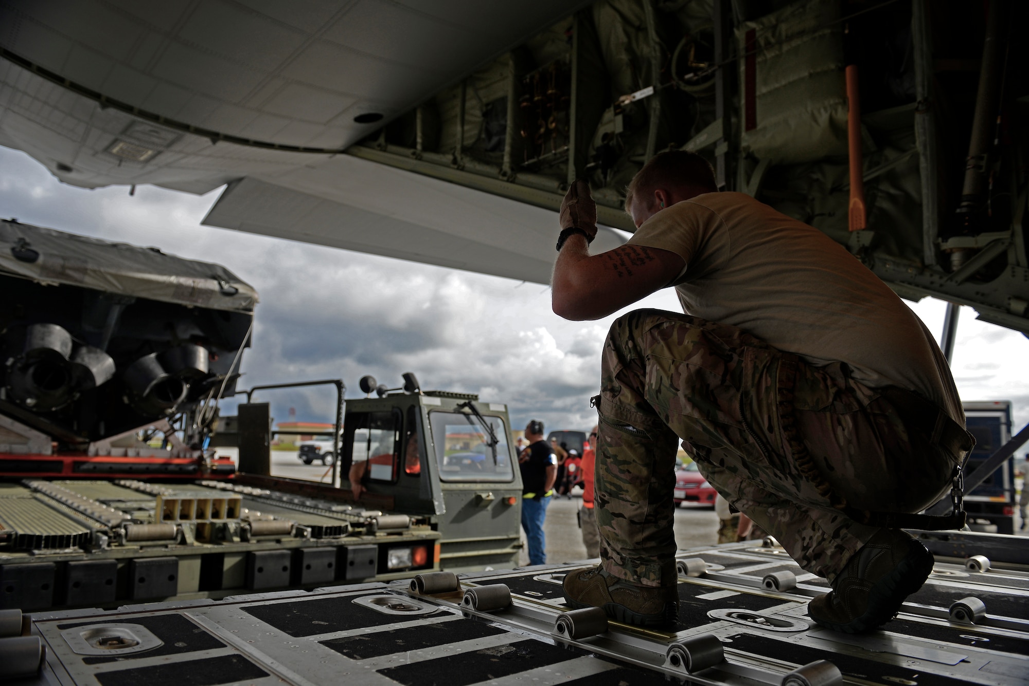 A 17th Special Operations Squadron MC-130J Commando II loadmaster, guides the driver of a load carrier toward an MC-130J Commando II during an exercise Sept. 18, 2015, at Andersen Air Force Base, Guam. The MC-130J was part of a dissimilar formation with an MC-130H that completed a Maritime Craft Aerial Delivery System airdrop. This was the first time an MC-130J Commando II completed the MCADS airdrop in the Pacific. (U.S. Air Force photo by Staff Sgt. Alexander Riedel/Released)