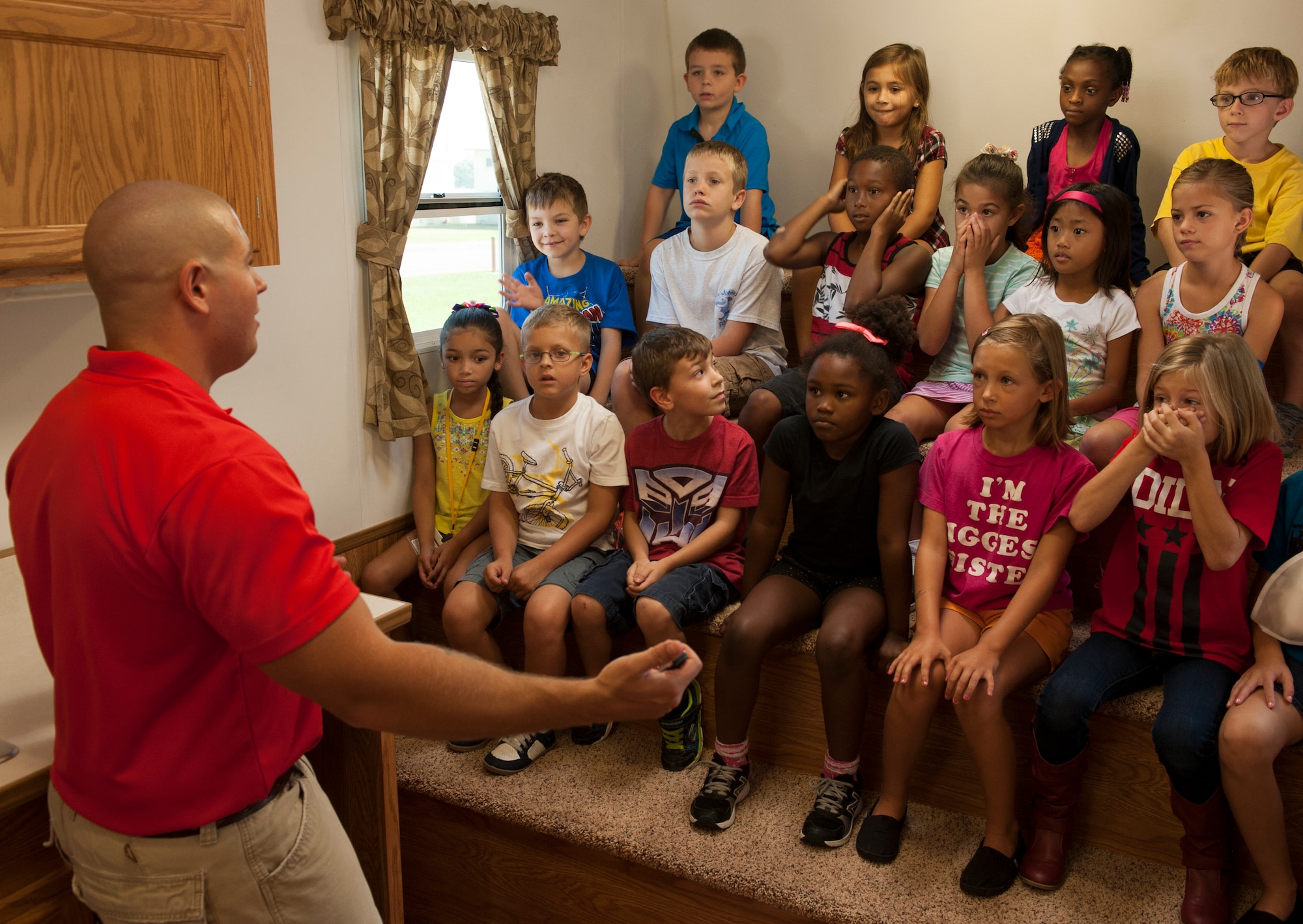 U.S. Air Force Staff Sgt. Cory Challenger, 18th Civil Engineer Squadron firefighter, talks to school children about the importance of testing smoke alarms in homes at Kadena Elementary School Oct. 7, 2015, on Kadena Air Base, Japan. In the spirit of Fire Prevention Week, the children were educated on fire safety information such as how often to check smoke alarms and what to do in the event of a fire. (U.S. Air Force photo by Airman 1st Class Corey M. Pettis)