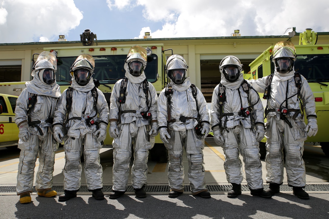 Aircraft Rescue and Fire Fighting Marines with Headquarters and Headquarters Squadron, pose for a picture in their proximity gear Aug. 31 on Marine Corps Air Station Futenma. ARFF Marines are trained to fight aircraft fires and serve as one of the safety measures in place on MCAS Futenma in case of incidents. The squadron, H&HS, MCAS Futenma, Marine Corps Installations Pacific-Marine Corps Base Camp Butler, Japan, reached 100,000 flight hours without incident Oct. 1.