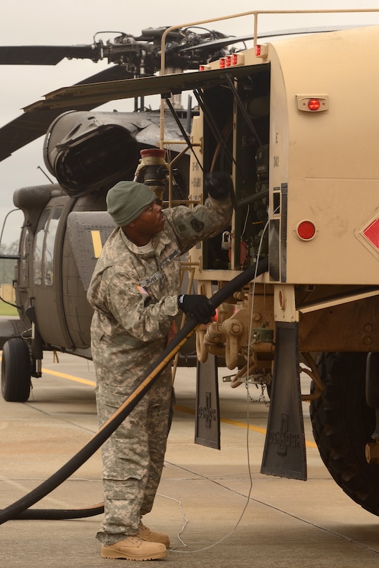 Army Staff Sgt. Dwayne Dove refuels a UH-60 Black Hawk helicopter at McEntire Joint National Guard Base, S.C., Oct. 5, 2015, in preparation to conduct rescue and emergency response operations throughout the state. Dove is assigned to the South Carolina Army National Guard's 1st Battalion, 151st Attack Reconnaissance Battalion. South Carolina Air National Guard photo by Senior Master Sgt. Edward Snyder