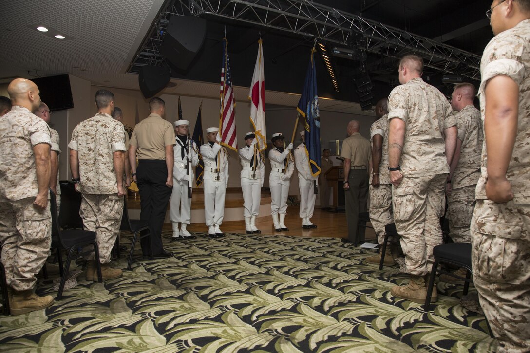 U.S. Marines and U.S. Navy sailors stand for colors during a cake cutting ceremony at the Palms Club on Camp Hansen, Okinawa, Japan, Oct. 9, 2015. The cake cutting ceremony signified the U.S. Navy’s 240 years in service as a branch of the U.S. Armed Forces. (U.S. Marine Corps photo by LCpl. Makenzie Fallon/Released)