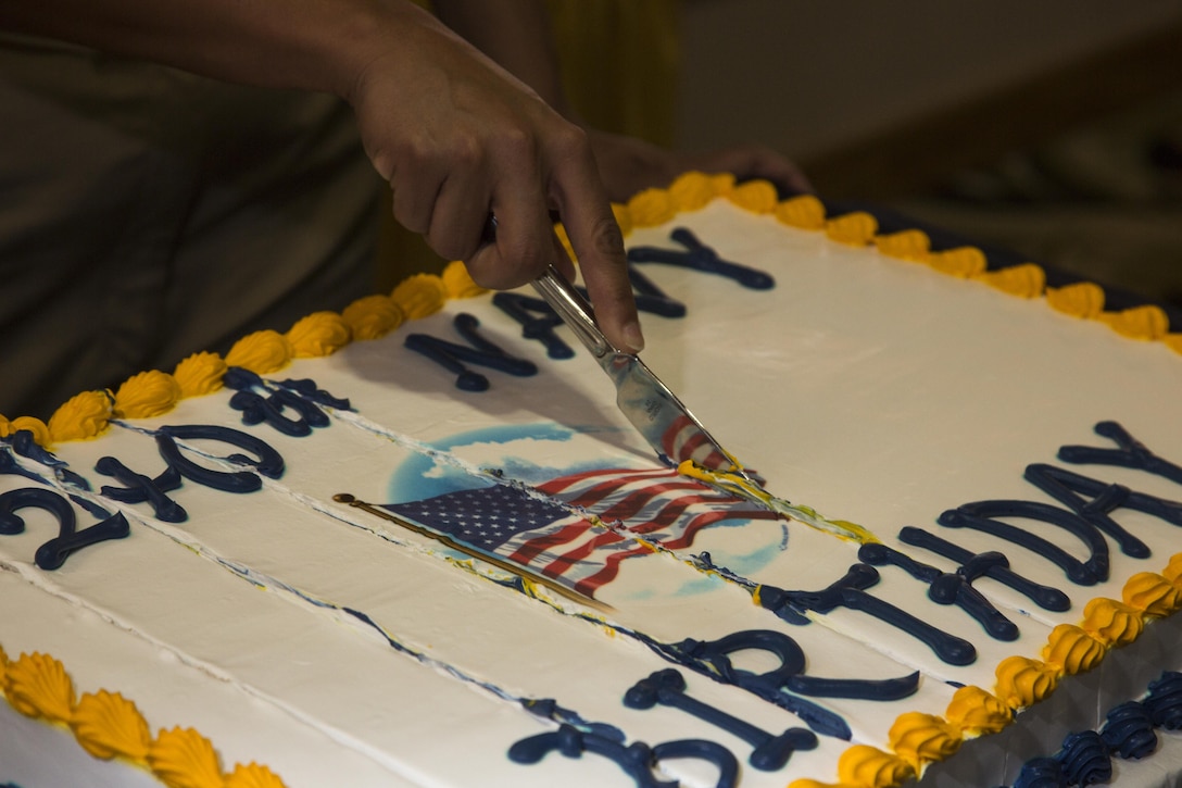 U.S. Navy HMC Leonor Casiano, Chief Hospital Corpsman, with the Okinawa U.S. Naval Hospital, cuts cake after a cake cutting ceremony at the Palms Club on Camp Hansen, Okinawa, Japan, Oct. 9, 2015. The cake cutting ceremony signified the U.S. Navy’s 240 years in service as a branch of the U.S. Armed Forces. (U.S. Marine Corps photo by LCpl. Makenzie Fallon/Released)