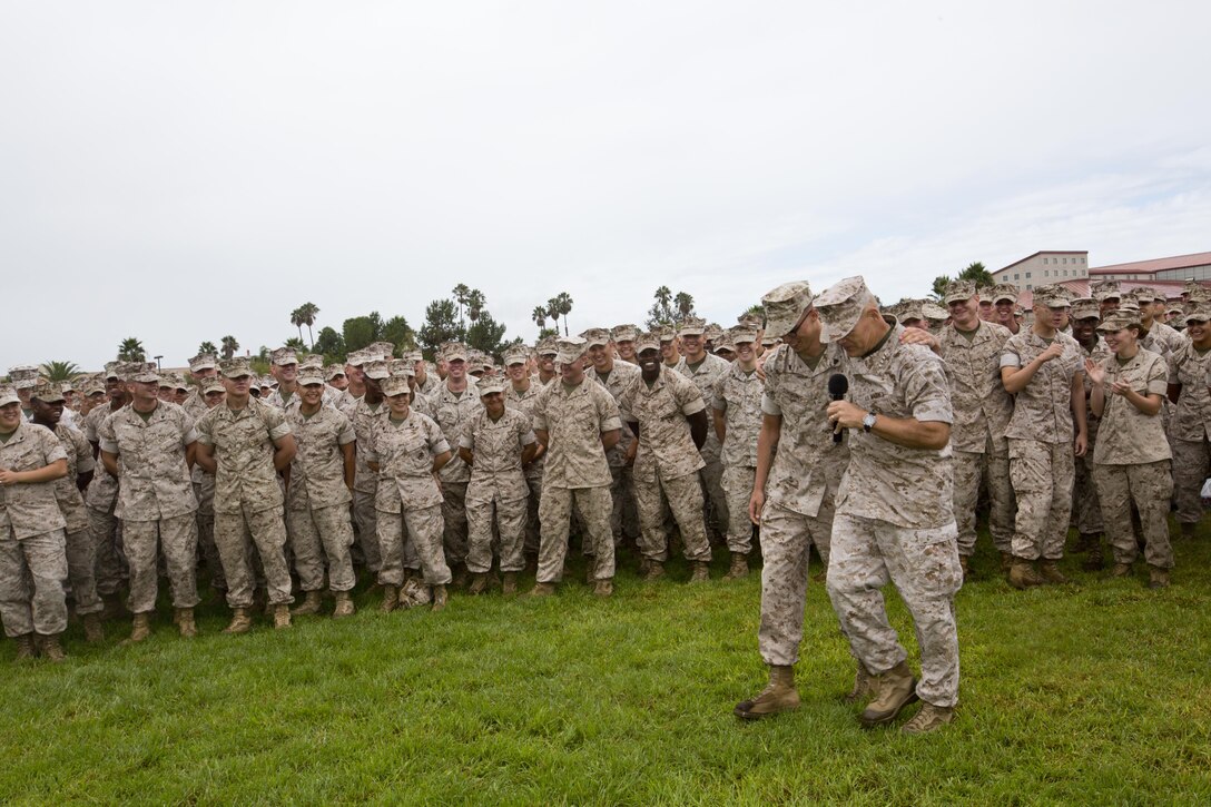 Commandant of the Marine Corps, Gen. Robert B. Neller, walks and speaks to a Marine during his visit at the Mainside Parade Deck, Camp Pendleton, Calif., Oct. 5, 2015. Neller outlined the Corps current priorities, expectations, listened and answered Marines' questions. (U.S. Marine Corps photo by Sgt. Gabriela Garcia/Released)