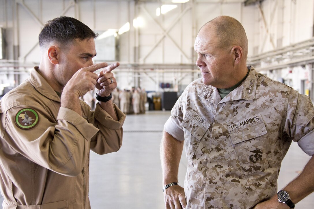 Commandant of the Marine Corps, Gen. Robert B. Neller, listens to a Marine at Marine Corps Air Station Yuma, Ariz., Oct. 7, 2015. Neller outlined the Corps current priorities, expectations, listened and answered Marines' questions during his Yuma visit. (U.S. Marine Corps photo by Sgt. Gabriela Garcia/Released)