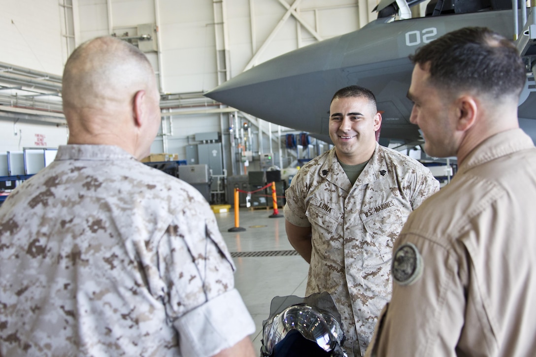 Commandant of the Marine Corps, Gen. Robert B. Neller, interacts with a Marine at Marine Corps Air Station Yuma, Ariz., Oct. 7, 2015. Neller outlined the Corps current priorities, expectations, listened and answered Marines' questions during his Yuma visit. (U.S. Marine Corps photo by Sgt. Gabriela Garcia/Released)