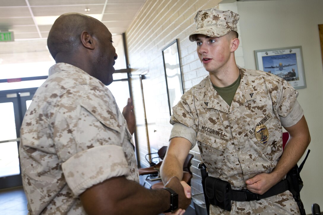 Sgt. Maj. of the Marine Corps Ronald L. Green, left, shakes hands with a Marine at Marine Corps Air Station, Ariz., Oct. 7, 2015. Commandant of the Marine Corps, Gen. Robert B. Neller, and Green outlined the Corps current priorities, expectations, listened and answered Marines' questions during their Yuma visit. (U.S. Marine Corps photo by Sgt. Gabriela Garcia/Released)