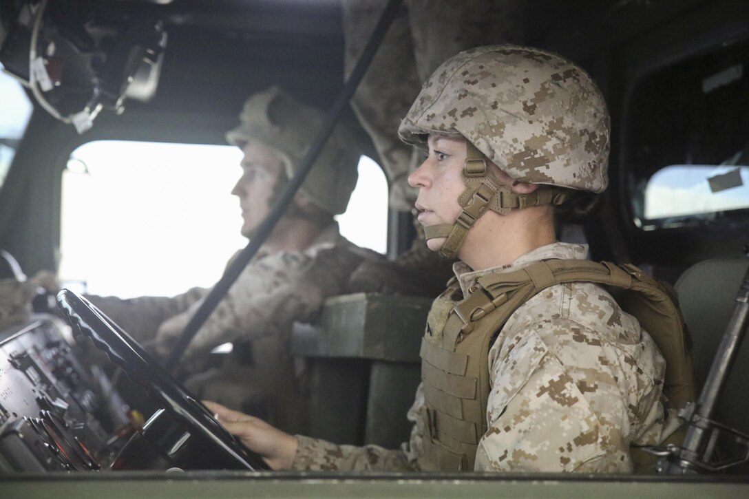 Cpl. Mason Archer, left, and Pfc. Crystal Canzius, right, both motor transport operators with Transportation Support Co., Combat Logistics Battalion 2, conduct simulated High Mobility Multipurpose Wheeled Vehicle convoy training at Camp Lejeune, N.C., Oct. 7, 2015. Approximately 25 Marines with the unit are undergoing Convoy Leader’s Course in preparation for an Integrated Training Exercise in Twentynine Palms, Calif., later this month. (U.S. Marine Corps photo by Cpl. Lucas Hopkins/Released)