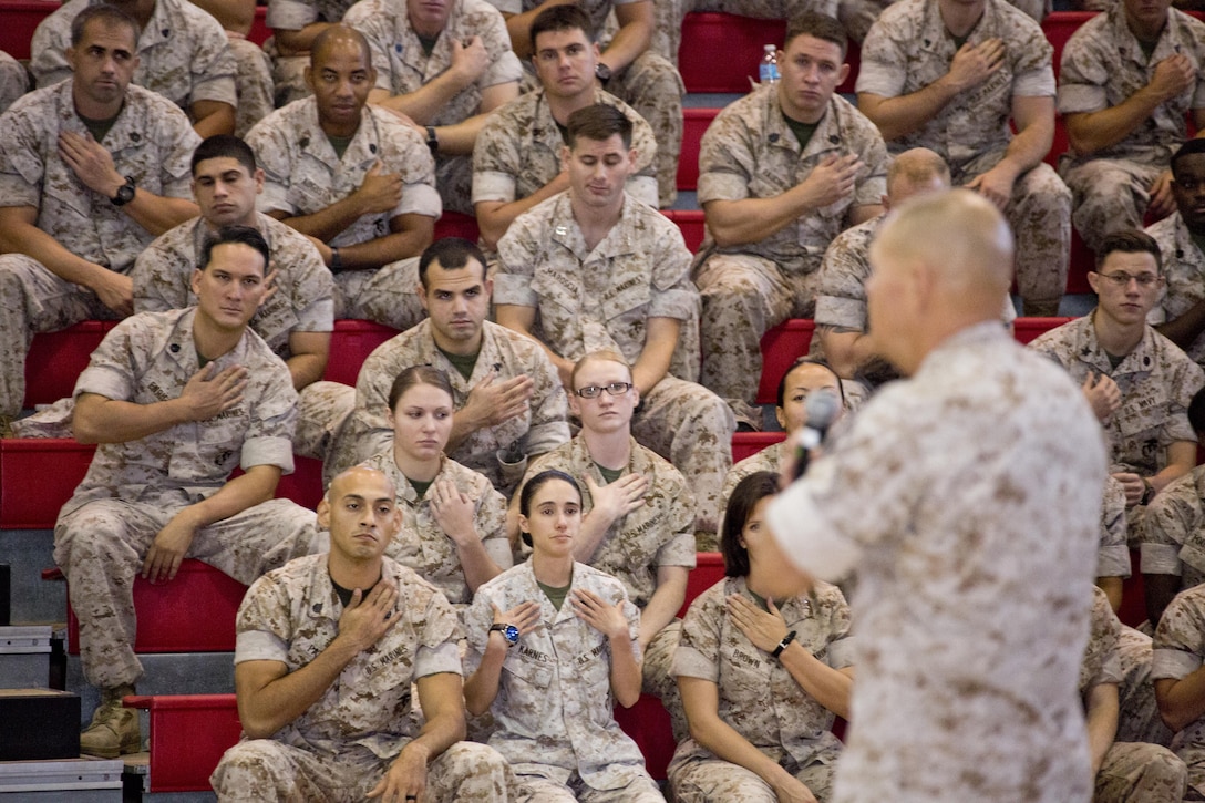 U.S. Marines touch their rank insignia while they listen to Commandant of the Marine Corps, Gen. Robert B. Neller, at Goettge Memorial Field House, Camp Lejeune, N.C., Oct. 8, 2015. Neller asked them to reflect on the work it took to earn it. (U.S. Marine Corps photo by Sgt. Gabriela Garcia/Released)