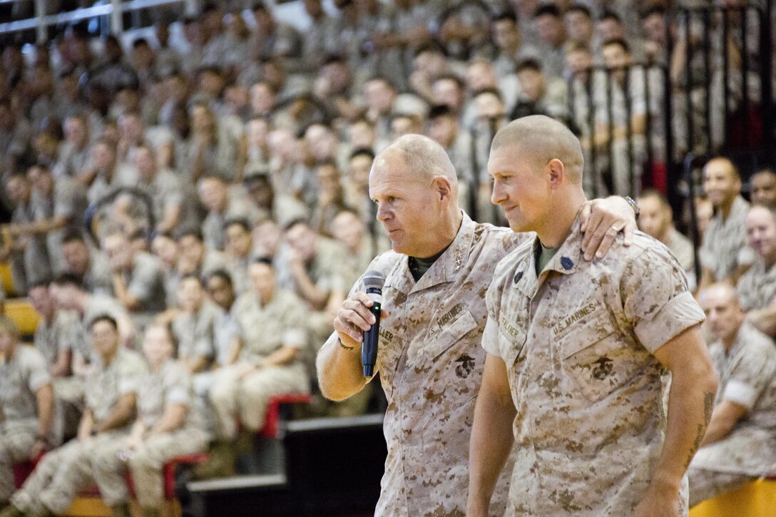 Commandant of the Marine Corps, Gen. Robert B. Neller, walks next to a Marine during a visit at Goettge Memorial Field House, Camp Lejeune, N.C., Oct. 8, 2015. Neller brought the Marine down the field house as he answered his question. (U.S. Marine Corps photo by Sgt. Gabriela Garcia/Released)