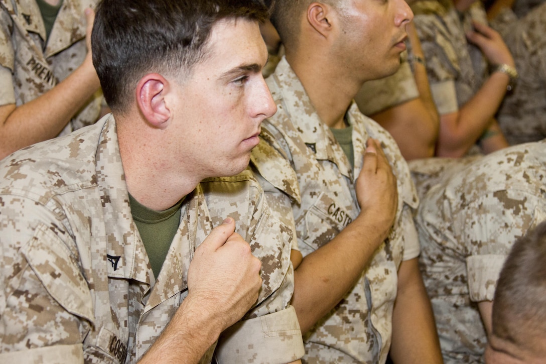 U.S. Marine Corps Lance Cpl. Matthew J. Cogdill, a flight line crew chief with Marine Medium Tiltrotor Training Squadron 204, touches his rank insignia while Commandant of the Marine Corps, Gen. Robert B. Neller, speaks at Marine Corps Air Station New River, N.C., Oct. 8, 2015. Neller asked Marines to reflect on the work it took to earn it. (U.S. Marine Corps photo by Sgt. Gabriela Garcia/Released)