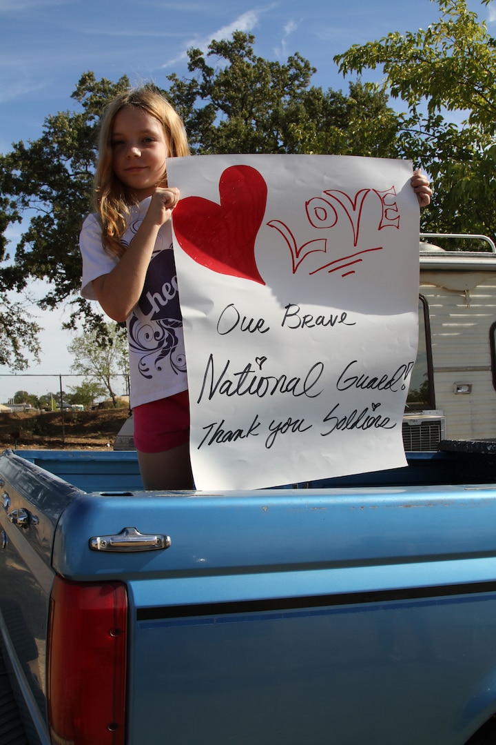 Camren Roebuck, a 9-year-old Angels Camp resident, holds a poster thanking California Army National Guardsmen assigned to the Butte Fire in Calaveras County, California, Sept. 24. Camren, a fourth-grader at Mark Twain Elementary School, was watching California Guard tactical vehicles return to base camp. 