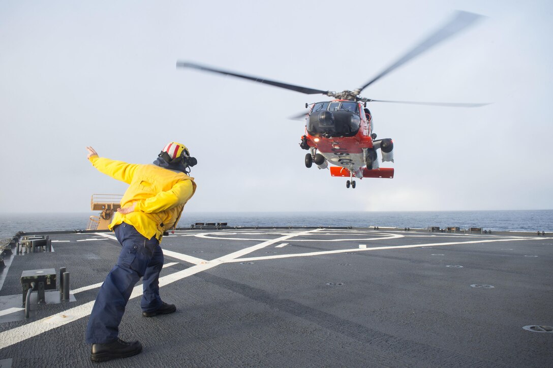 An HH-60 Jayhawk rescue helicopter lands on the flight deck of Coast Guard Cutter Healy in the southern Arctic Ocean, Oct. 7, 2015. The Healy is supporting the National Science Foundation-funded Arctic Geotraces project, part of an international effort to study the distribution of trace elements in the world's oceans. U.S. Coast Guard photo by Petty Officer 2nd Class Cory J. Mendenhall