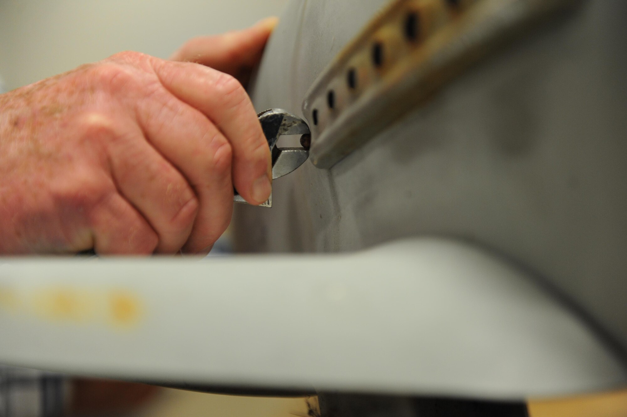Tom Capers, 81st Training Support Squadron machinist and welder, disassembles a pedal airplane during a refurbish project at the Trainer Development Center, Oct. 8, 2015, Keesler Air Force Base, Miss. The four pedal airplanes, belonging to the child development center, have been in storage for more than 10 years.  (U.S. Air Force photo by Kemberly Groue)