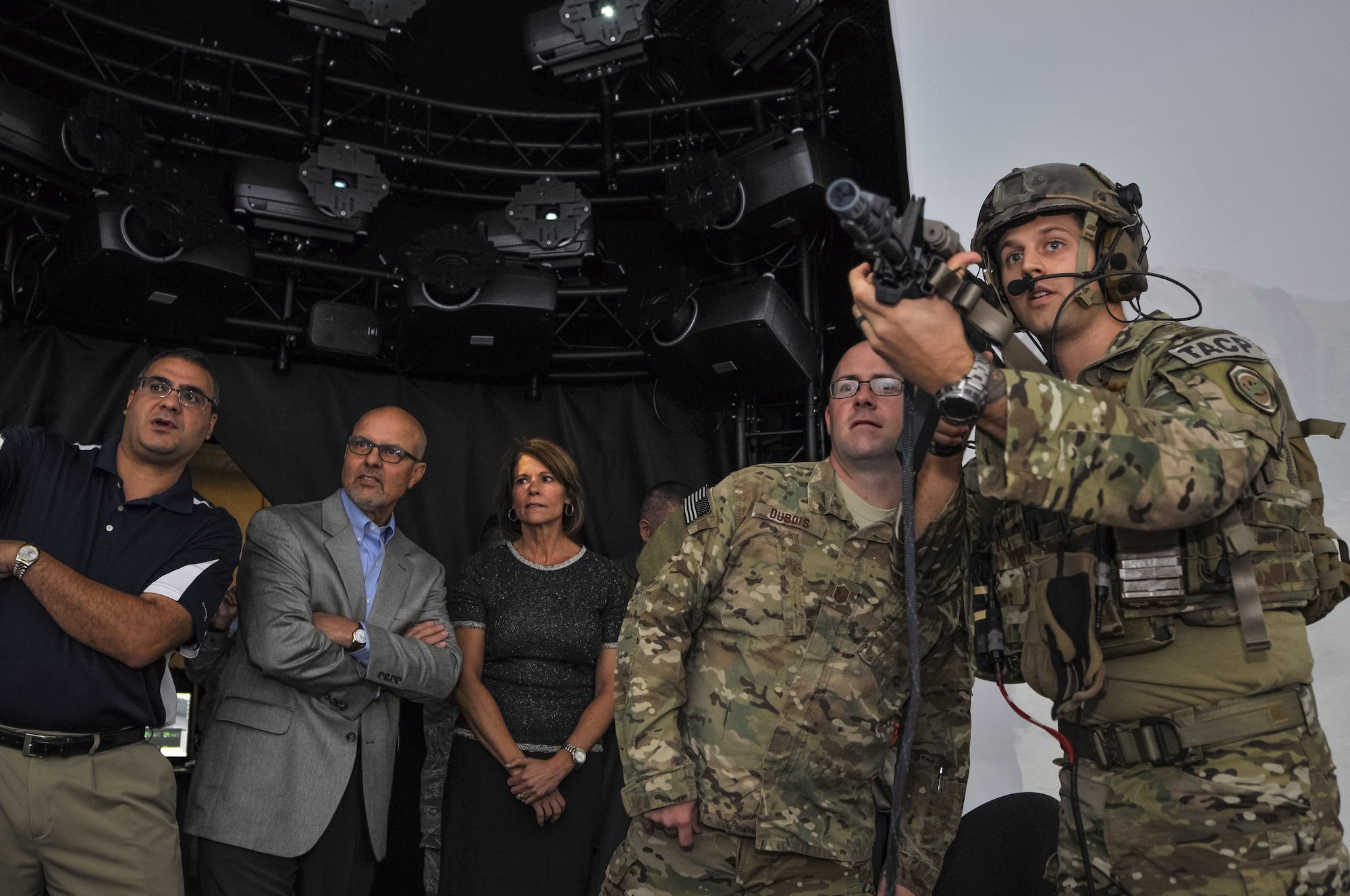 Tech. Sgt. Cody L. Canfield, tactical air control party specialist with the 169th Air Support Operations Squadron, Illinois Air National Guard, uses an LA-5 to illuminate a target while, from left, state Rep. Michael Unes, R-Ill., state Sen. David Koehler, D-Ill., and U.S. Rep. Cheri Bustos, D-Ill., watch during a demonstration of the Air National Guard Advanced Joint Terminal Attack Controller Training System at the 182nd Airlift Wing in Peoria, Ill., Oct. 5, 2015. Peoria’s TACPs teamed up with the QuantaDyn Corporation to help create the AAJTS, which is expected to potentially save the government $95 million through fiscal year 2018 by reducing the cost of qualification and continuation training by 48 percent. (U.S. Air National Guard photo/Staff Sgt. Lealan Buehrer)