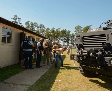 Rapides Sheriff's Office deputies and Pineville Police Department officers detain one of the role-players during a multi-layered anti-terrorism training scenario at Camp Beauregard in Pineville, Louisiana, Oct. 7, 2015. 