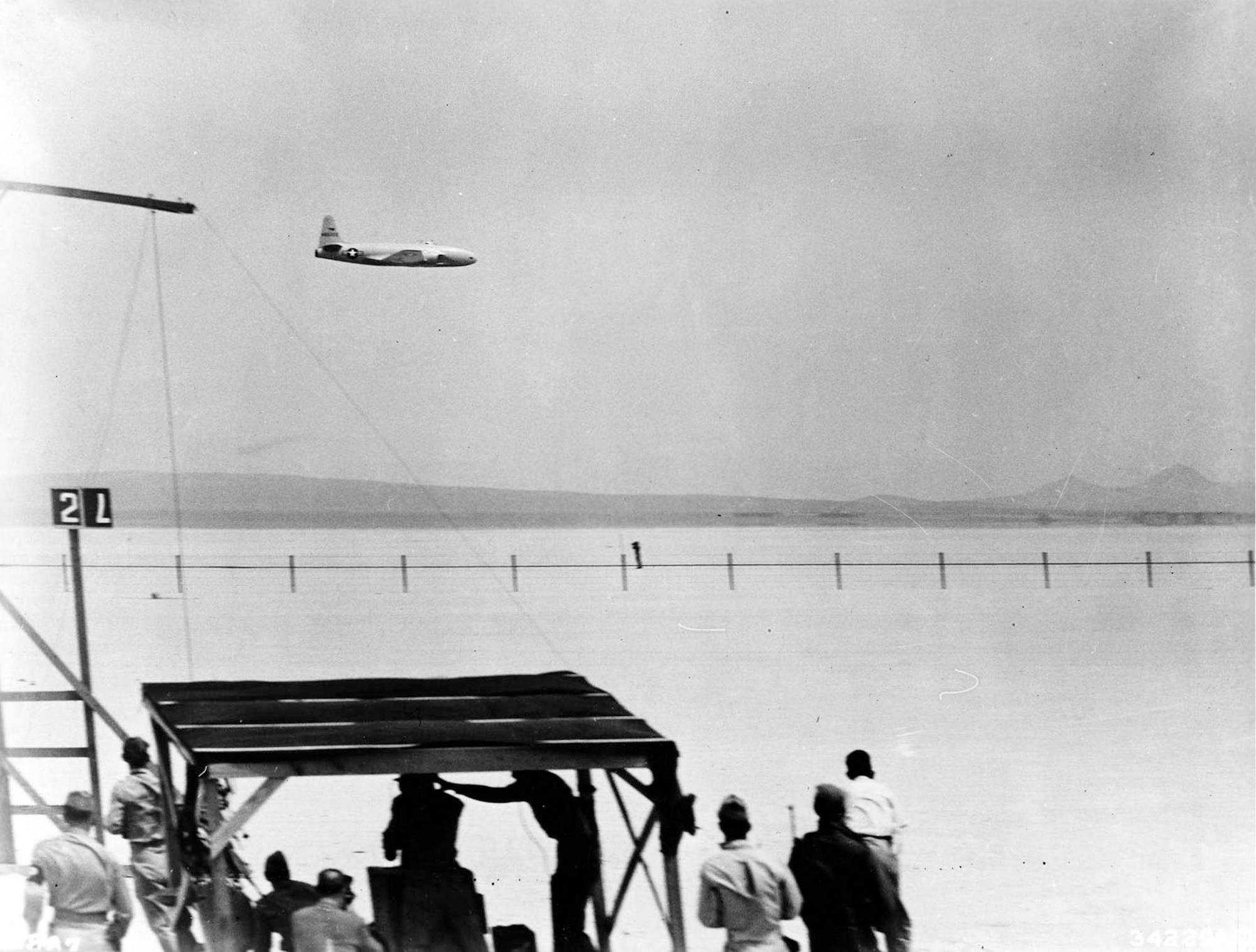 P-80R flying past a speed marking station at Muroc Army Air Field. On June 19, 1947, at Muroc Army Air Field (now Edwards Air Force Base), Calif., Col. Albert Boyd flew this P-80R to a new world's speed record of 623.753 mph, returning the record to the United States after nearly 24 years. (U.S. Air Force photo)