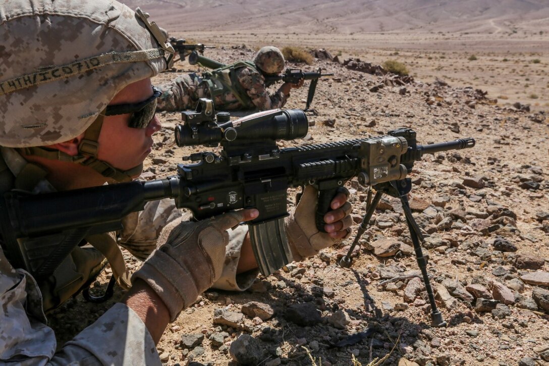 U.S. 5TH FLEET AREA OF OPERATIONS (Aug. 26, 2015)  U.S. Marine Cpl. Zackary Cox fires at targets alongside Jordanian Soldiers during a bilateral training evolution. Cox is an infantry automatic rifle gunner with India Company, Battalion Landing Team 3rd Battalion, 1st Marine Regiment, 15th Marine Expeditionary Unit. The 15th MEU is deployed throughout the U.S. 5th Fleet area of operations to maintain regional security. (U.S. Marine Corps photo by Sgt. Jamean Berry/Released)