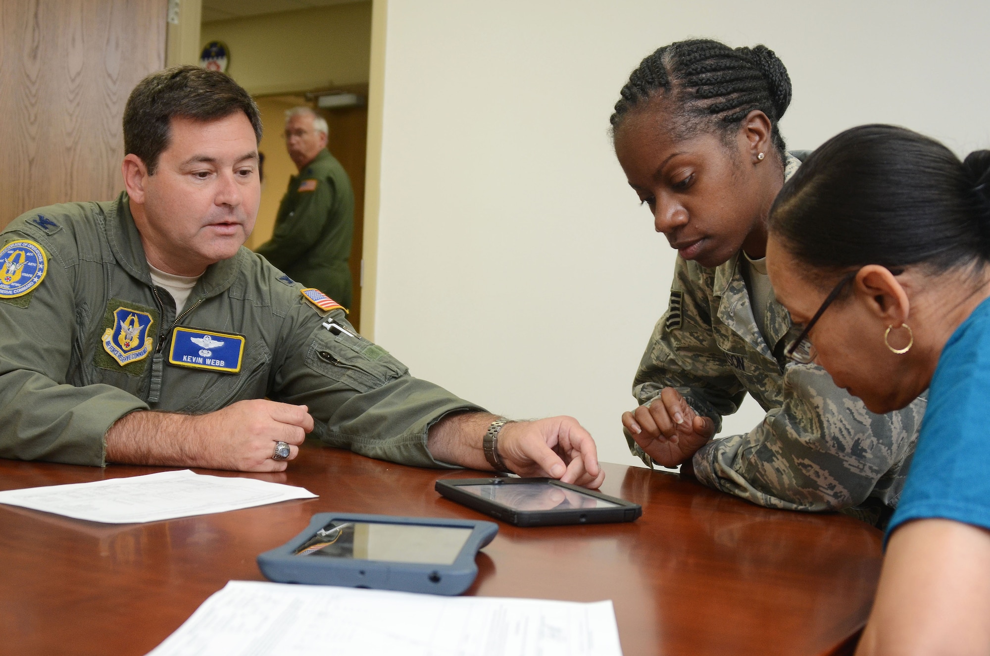 Col. Kevin Webb, Air Force Reserve Command Chief of Mobility Operations Division, demonstrates some of the functions of the Mobile Mission Kit during a test phase of the unit held at Dobbins Air Reserve Base, Ga. Sept. 29, 2015.  The device is designed to capture a wide variety of accurate and timely mission data using a paperless and real-time process, reducing crew workload, saving costs and improving overall efficiency before, during and after flying missions. (U.S. Air Force photo/Don Peek)