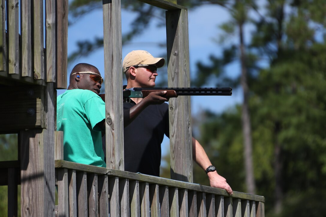 Cpl. Adelius Johnson aims his rifle at a moving target during a skeet range at Marine Corps Air Station Cherry Point, N.C., Oct. 7, 2015. Marines with 2nd Low Altitude Air Defense Battalion held a weapons safety class and participated in the range as part of their Firearms Mentorship Program to promote proper weapons safety and education in a recreational manor. The program allows Marines to maintain their basic rifleman skills and receive further education on safety measures while handling weapons. Johnson is a field radio operator with the battalion. (U.S. Marine Corps photo by Cpl. N.W. Huertas/Released)   