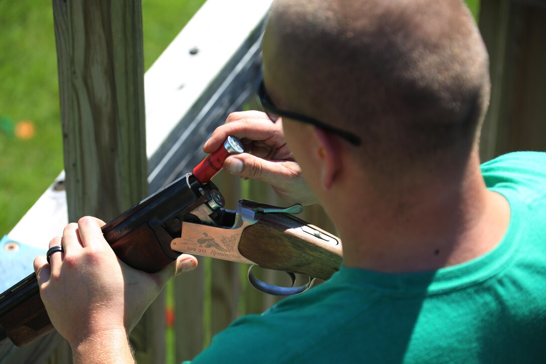Lance Cpl. Stephen Griffith loads rounds into the barrel of a rifle during a skeet range at Marine Corps Air Station Cherry Point, N.C., Oct. 7, 2015. Marines with 2nd Low Altitude Air Defense Battalion held a weapons safety class and participated in the range as part of their Firearms Mentorship Program to promote proper weapons safety and education in a recreational manor. The program allows Marines to maintain their basic rifleman skills and receive further education on safety measures while handling weapons. Griffith is an automotive maintenance technician with the battalion. (U.S. Marine Corps photo by Cpl. N.W. Huertas/Released)    