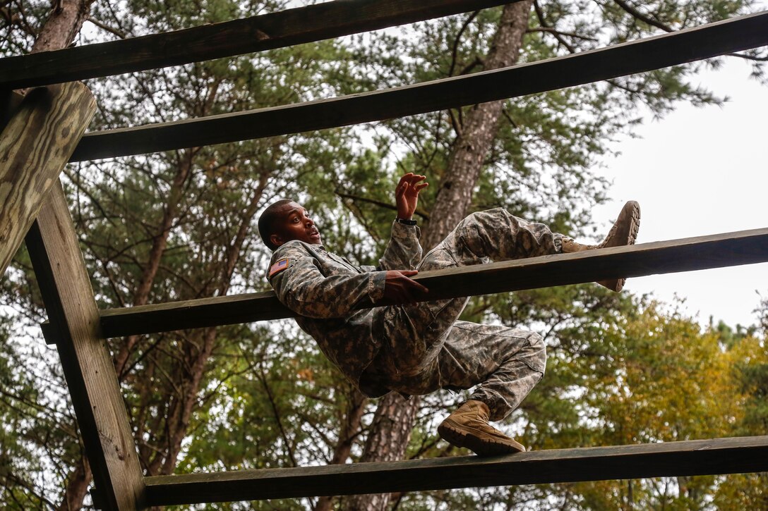 U.S. Army Sgt. Kristopher A. Grayson participates in the obstacle course portion of the U.S Army's Best Warrior Competition on Fort A.P. Hill, Va., Oct. 5, 2015. The weeklong competition tests the skills, knowledge and professionalism of 26 warriors representing 13 commands. Grayson is assigned to Headquarters and Headquarters Company, 53rd Signal Battalion, U.S. Army Space and Missile Defense Command. U.S. Army photo by Spc. Wes Conroy