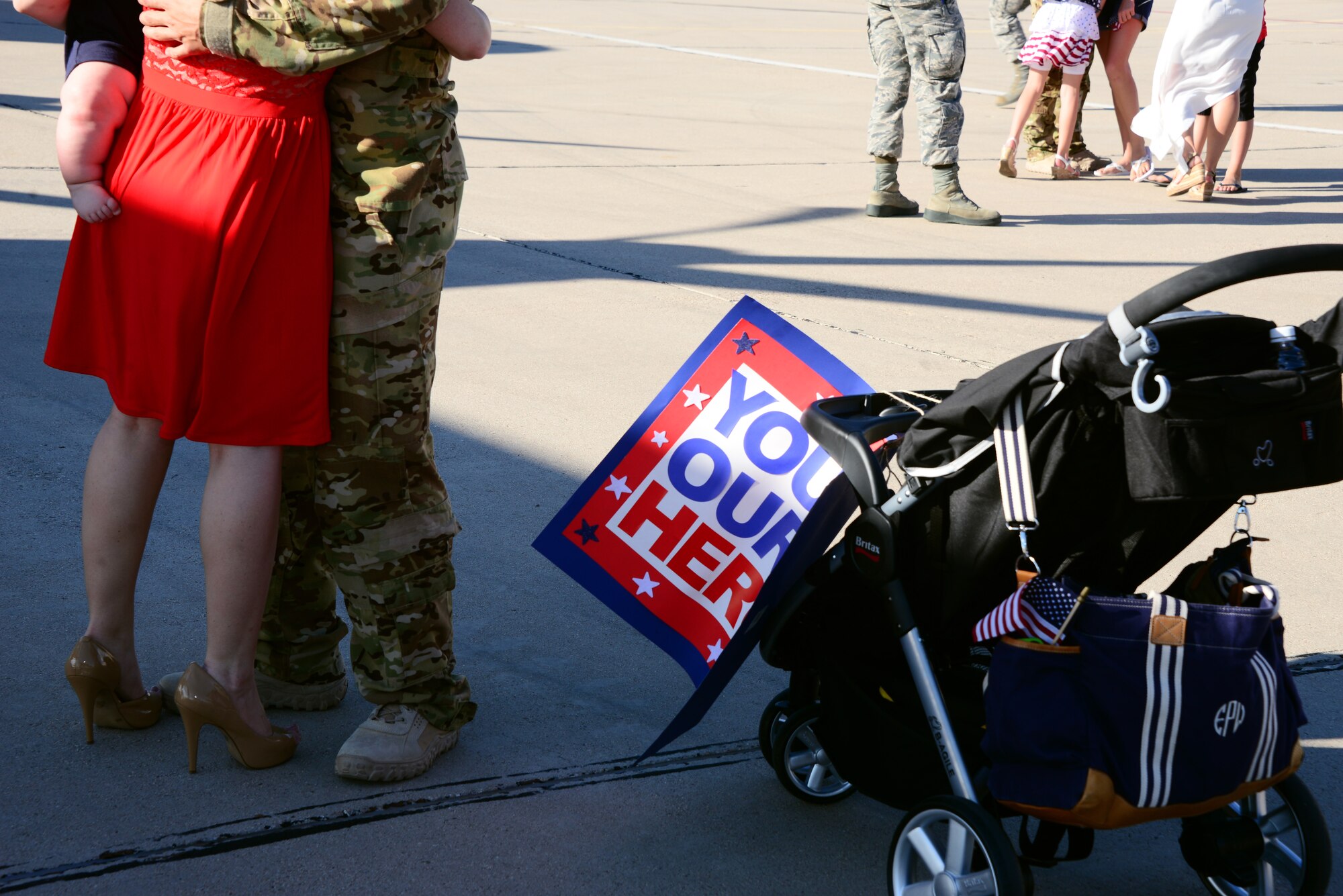 U.S. Air Force Capt. Nick Pettit, 563rd Operation Support Squadron, hugs his family on the flightline at Davis-Monthan Air Force Base, Ariz., Oct. 9, 2015. Two HC-130J Combat King IIs and 25 Airmen returned from a 4-month deployment to Southwest Asia. (U.S. Air Force photo by Airman 1st Class Mya M. Crosby/Released)