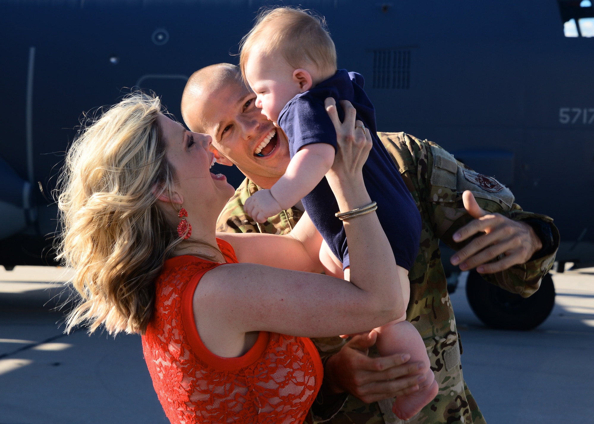 U.S. Air Force Capt. Nick Pettit, 563rd Operation Support Squadron, embraces his family on the flightline at Davis-Monthan Air Force Base, Ariz., Oct. 9, 2015. Two HC-130J Combat King II’s and 25 Airmen returned from a 4-month deployment to Southwest Asia. (U.S. Air Force photo by Airman 1st Class Mya M. Crosby/Released)