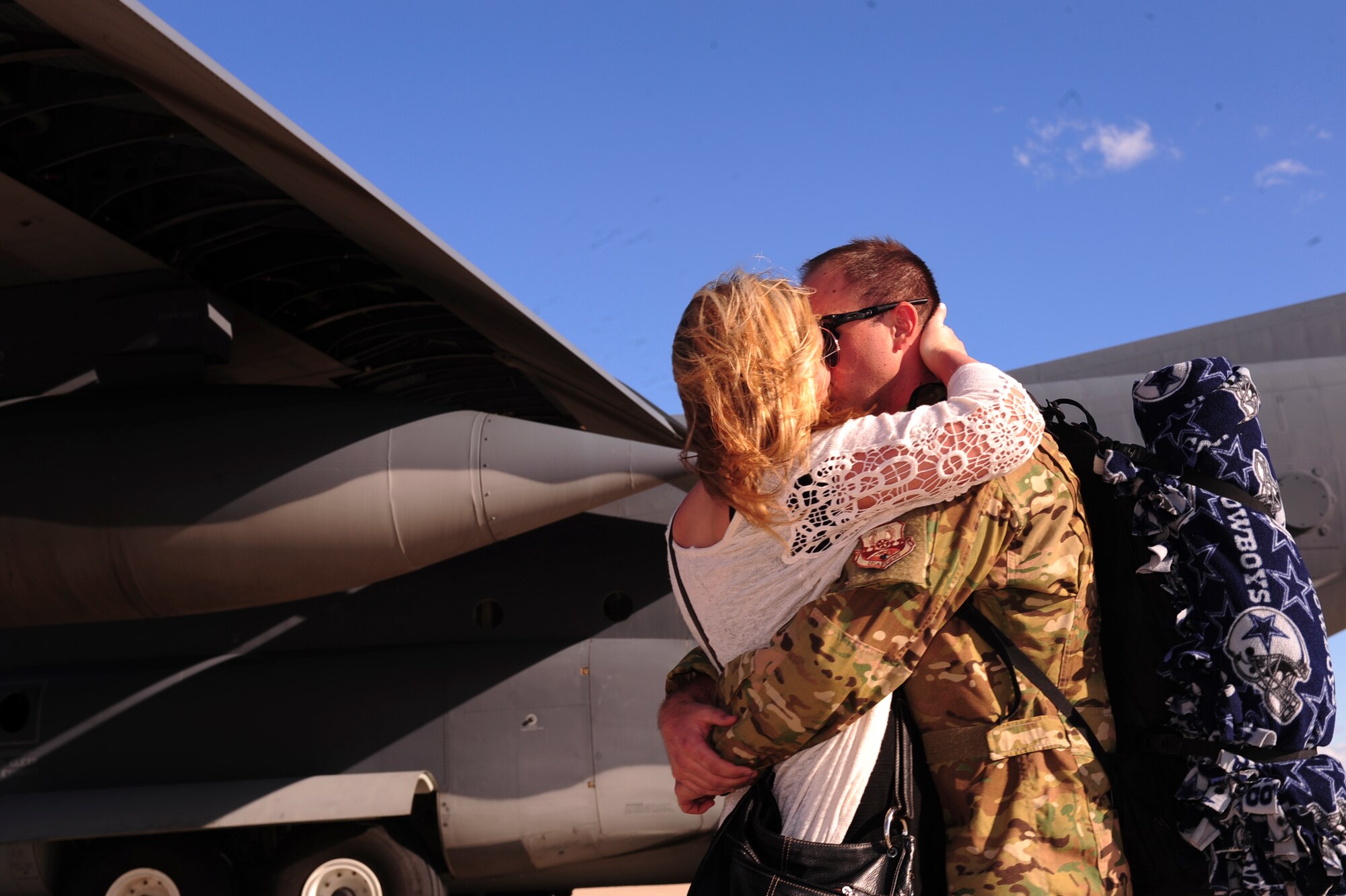 U.S. Air Force Staff Sgt. Tim Fitzpatrick, 563rd Operations Support Squadron loadmaster, embraces his wife, Laura Fitzpatrick, on the flightline at Davis-Monthan Air Force Base, Ariz., Oct. 9, 2015. Two HC-130J Combat King II’s and 25 Airmen returned from a 4-month deployment to Southwest Asia. (U.S. Air Force photo by Airman Basic Nathan H. Barbour/Released)