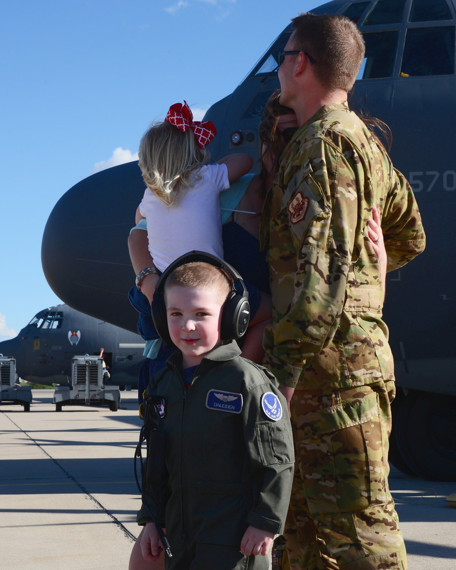 U.S. Air Force Capt. Josh Daleiden, 79th Rescue Squadron executive officer, embraces his family on the flightline at Davis-Monthan Air Force Base, Ariz., Oct. 9, 2015. Two HC-130J Combat King II’s and 25 Airmen returned from a 4-month deployment to Southwest Asia. (U.S. Air Force photo by Airman 1st Class Mya M. Crosby/Released) 