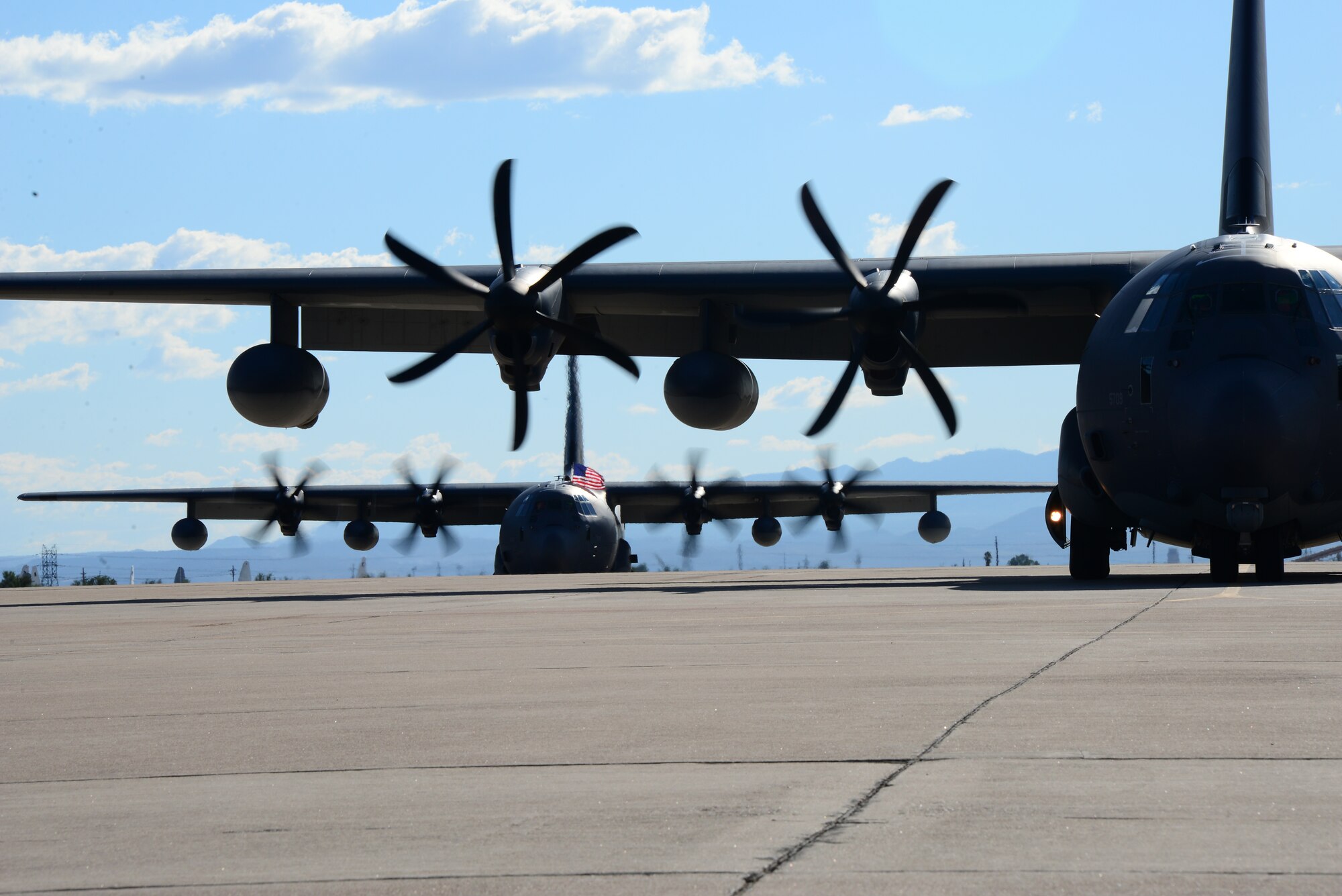 Two HC-130J Combat King IIs prepare to park on the flightline at Davis-Monthan Air Force Base, Ariz., Oct. 9, 2015. The HC-130Js carried approximately 25 Airmen home after a 4-month deployment to Southwest Asia. (U.S. Air Force photo by Airman 1st Class Mya M. Crosby/Released)
