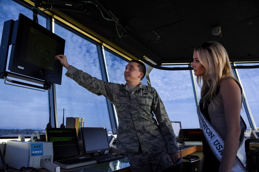 Senior Airman Kelvin McLaughlin, 92nd Operations Support Squadron air traffic controller, explains airfield operations in the control tower to Kenzi Novell, Miss Washington, USA, during a base tour Oct. 9, 2015, at Fairchild Air Force Base, Wash. Novell is a graduate of Gonzaga University and has resided in Spokane her entire life. (U.S. Air Force photo/Senior Airman Janelle Patiño)