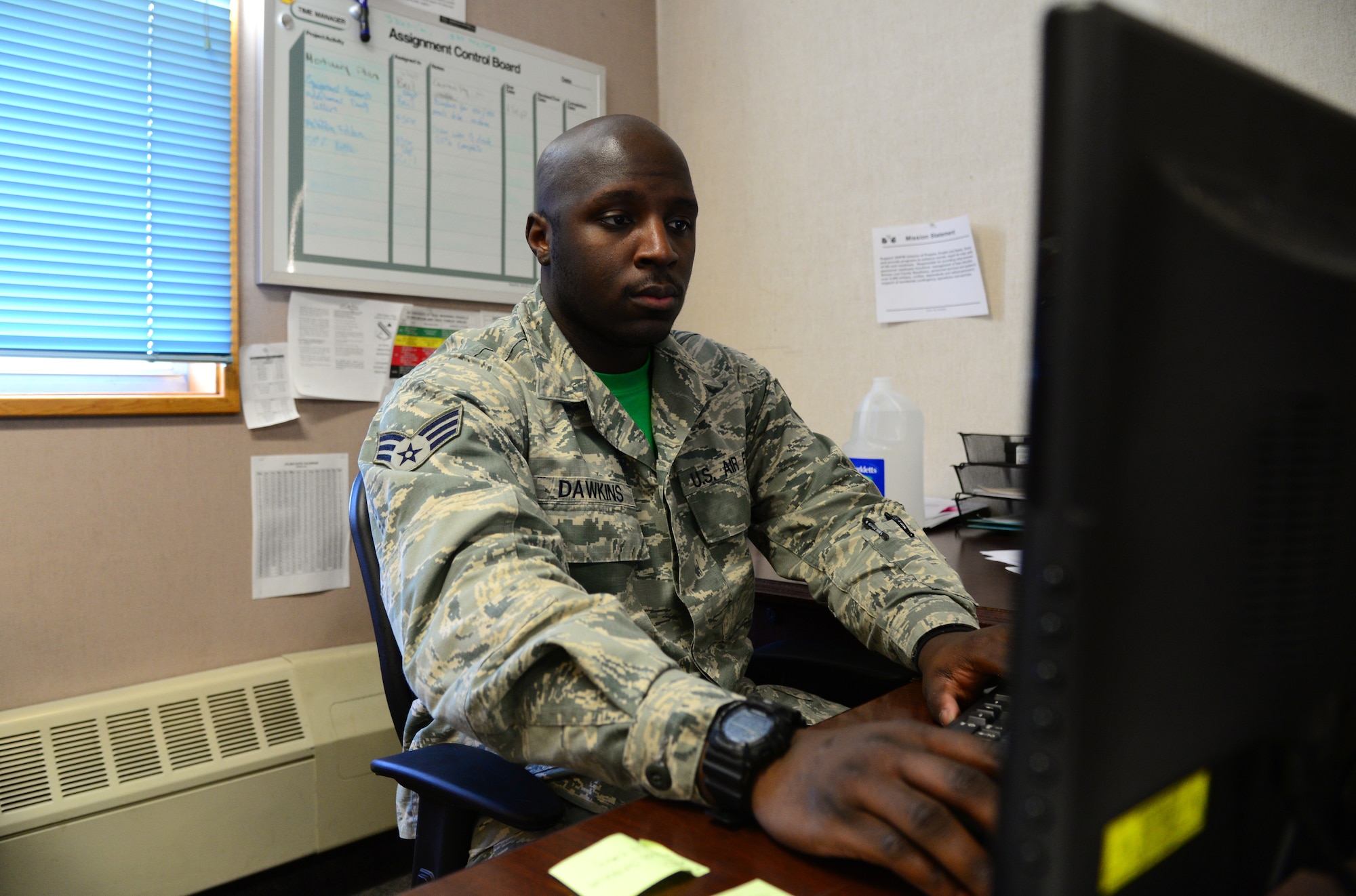 U.S. Air Force Senior Airman Devarius Dawkins, a 354th Force Support Squadron readiness and plans journeyman, checks over personnel training records Oct. 9, 2015, at Eielson Air Force Base, Alaska. Dawkins uses these records to make sure personnel are up-to-date on all required training. (U.S. Air Force photo by Airman 1st Class Cassandra Whitman/Released)
