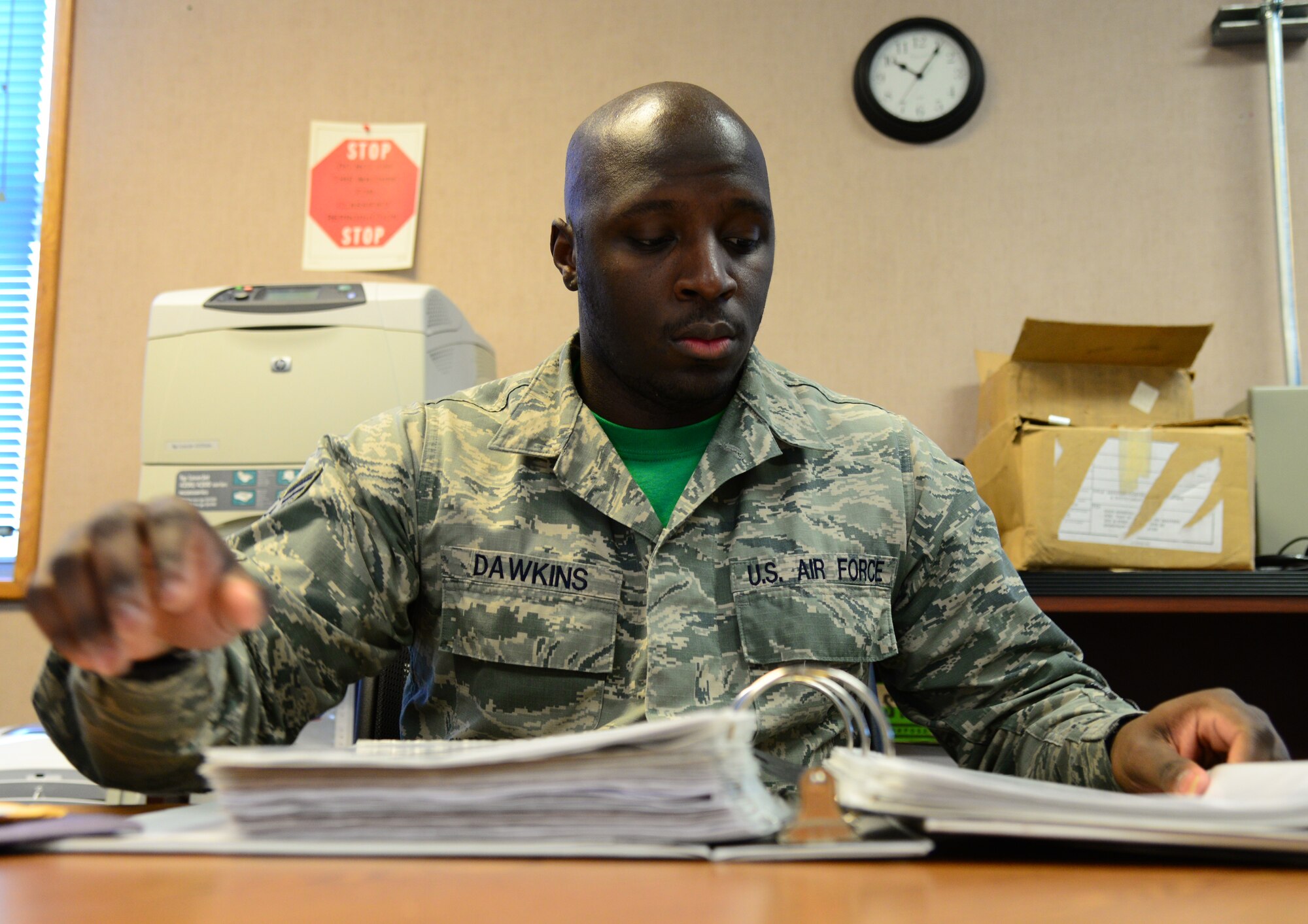 U.S. Air Force Senior Airman Devarius Dawkins, a 354th Force Support Squadron readiness and plans journeyman, flips through the vehicle control officer (VCO) binder Oct. 9, 2015, at Eielson Air Force Base, Alaska. Dawkins uses this binder to keep track of the paperwork that goes with the VCO program.  (U.S. Air Force photo by Airman 1st Class Cassandra Whitman/Released)