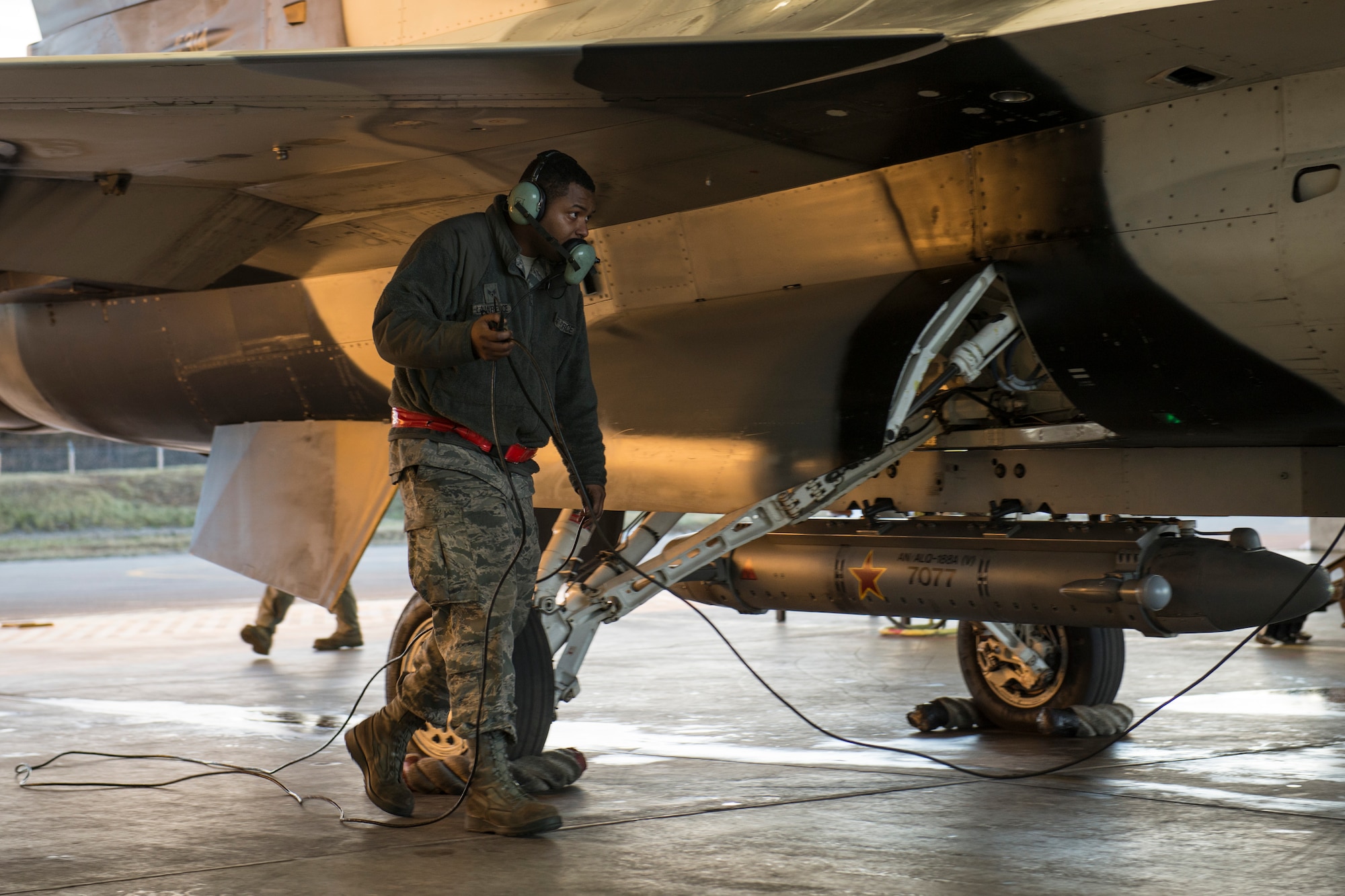 U.S. Air Force Senior Airman Terrence Lawrence, a 354th Aircraft Maintenance Squadron aircraft electrical and environmental systems journeyman, prepares an F-16 Fighting Falcon assigned to the 18th Aggressor Squadron at Eielson Air Force Base, Alaska, for a mission Oct. 8, 2015. Lawrence is cross utilized from a different maintenance career field to perform crew chief tasks because crew chiefs are undermanned 50 percent. (U.S. Air Force photo by Staff Sgt. Joshua Turner/Released)