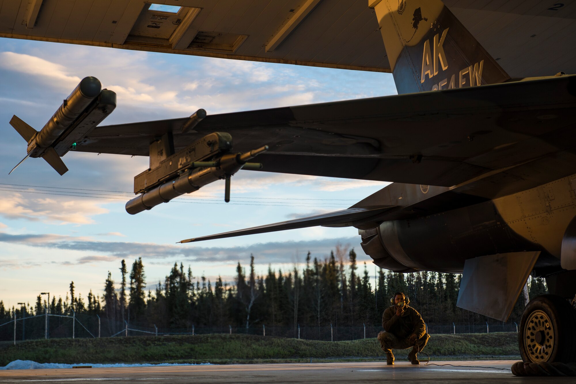 U.S. Air Force Senior Airman Terrence Lawrence, a 354th Aircraft Maintenance Squadron aircraft electrical and environmental systems journeyman, prepares an F-16 Fighting Falcon assigned to the 18th Aggressor Squadron at Eielson Air Force Base, Alaska, for a mission Oct. 8, 2015. Lawrence was the first Airman to complete a program called “cut training,” which cross utilizes Airmen to fill undermanned crew chief positions. (U.S. Air Force photo by Staff Sgt. Joshua Turner/Released)