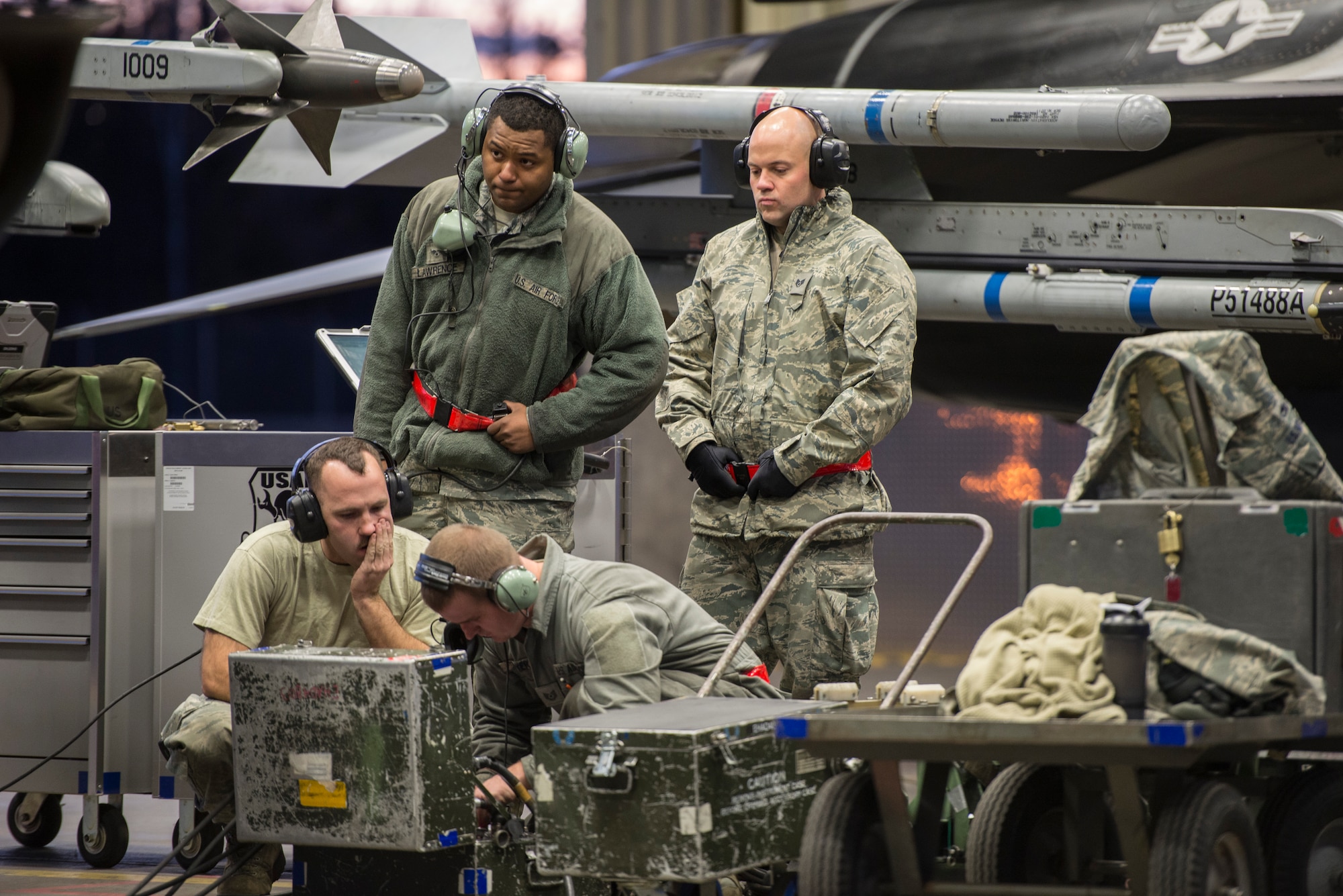 Members of the 354th Aircraft Maintenance Squadron (AMXS) troubleshoot an F-16 Fighting Falcon assigned to the 18th Aggressor Squadron at Eielson Air Force Base, Alaska, Oct. 8, 2015. The 354th AMXS created a program called “cut training” to cross utilize Airmen to fill undermanned crew chief positions. Lawrence was the first Airman to complete the program. (U.S. Air Force photo by Staff Sgt. Joshua Turner/Released)