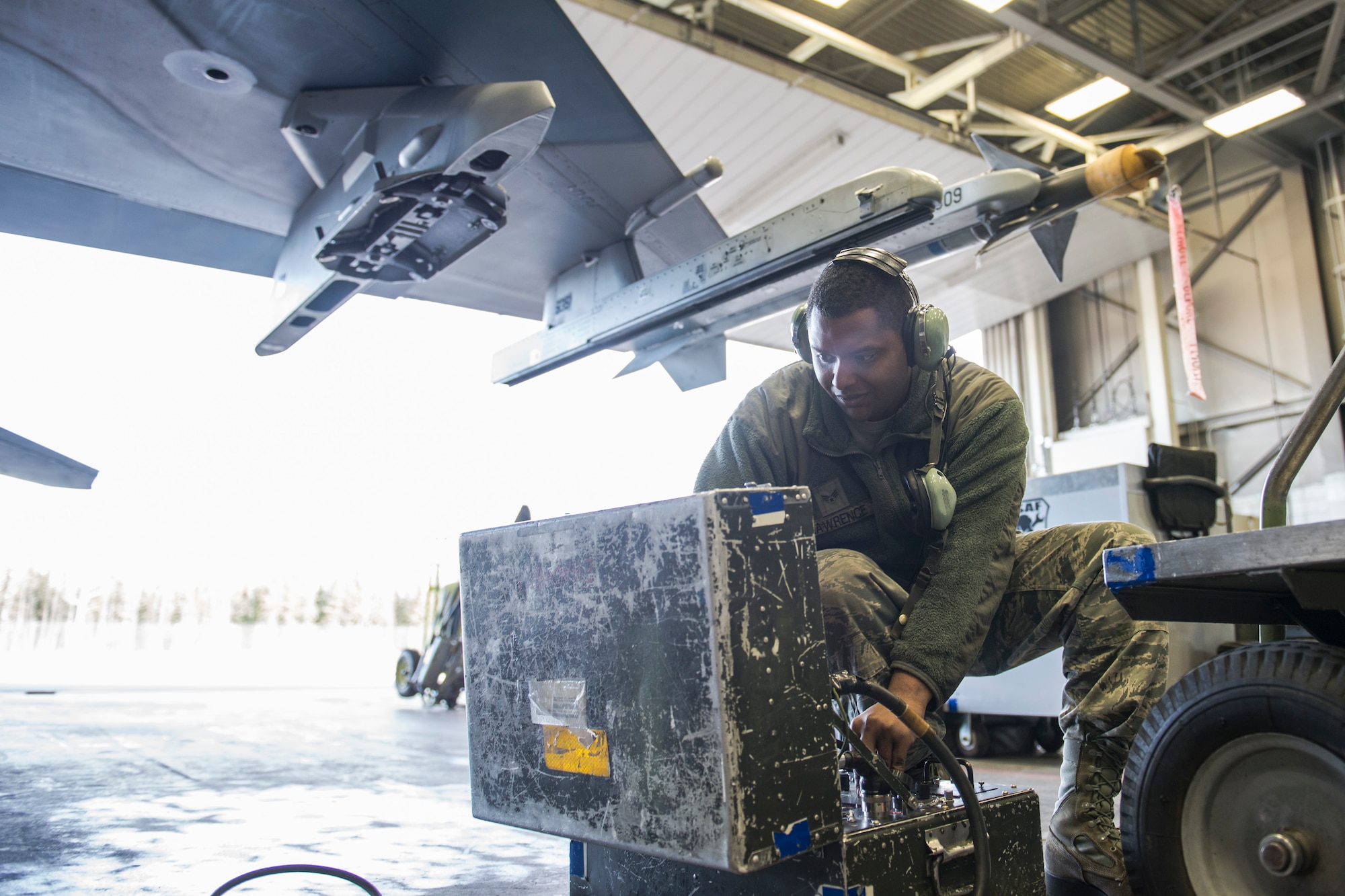U.S. Air Force Senior Airman Terrence Lawrence, a 354th Aircraft Maintenance Squadron aircraft electrical and environmental systems journeyman, troubleshoots an F-16 Fighting Falcon assigned to the 18th Aggressor Squadron at Eielson Air Force Base, Alaska, Oct. 7, 2015. Lawrence is cross utilized from a different maintenance career field to perform crew chief tasks because crew chiefs are undermanned 50 percent. (U.S. Air Force photo by Staff Sgt. Joshua Turner/Released)