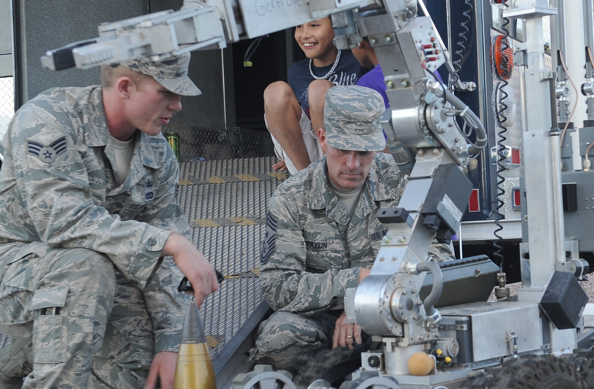 U.S. Air Force Senior Airman Mathew Shoup, 355th Civil Engineer Squadron explosive ordnance disposal technician, explains the capabilities of “Gertrude,” a F6A robot, to Chief Master Sgt. Jeremy Ravlin, 355th Fighter Wing command chief, during a National Night Out event held at Davis-Monthan Air Force Base, Ariz., Oct. 7, 2015. This is the ninth year that D-M has participated in the event however, the event has been happening for 34 years around the world. Neighbors celebrate in 16,124 communities from all fifty states, U.S. Territories, Canadian cities, and military bases worldwide. While most communities celebrate National Night Out on the first Tuesday in August, Soaring Heights holds its event during October due to Tucson’s extreme heat in August. (U.S. Air Force photo by Senior Airman Cheyenne A. Powers/Released)
